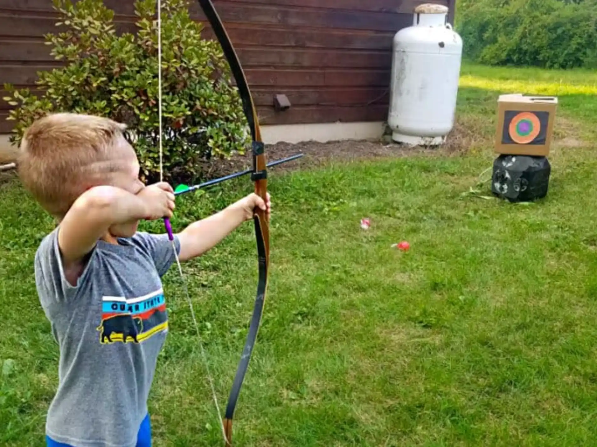 two boys playing with bows and arrows