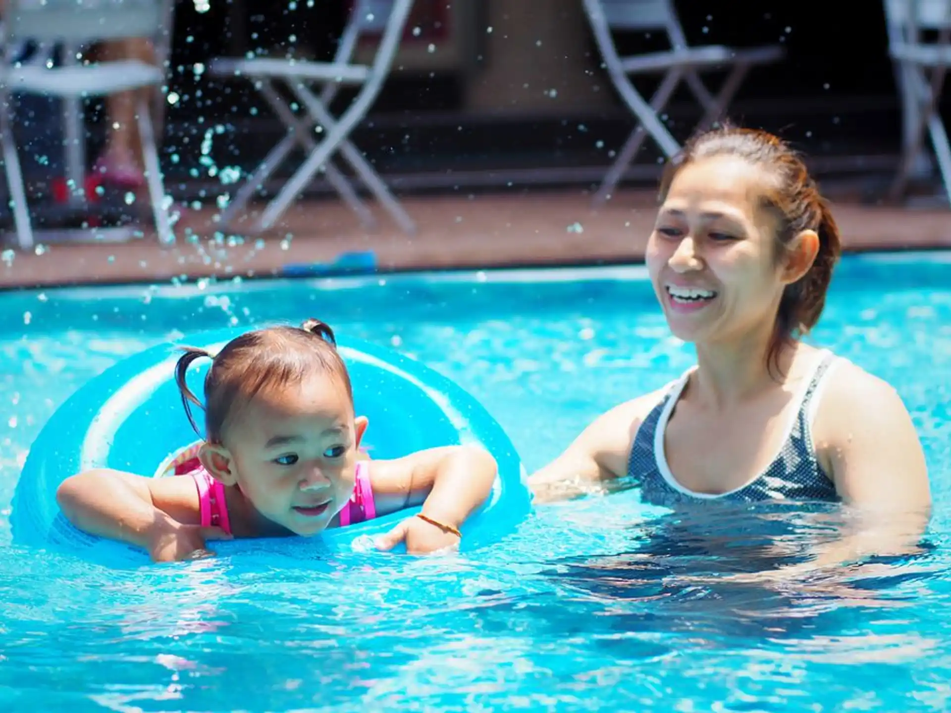 a person and a baby in a pool