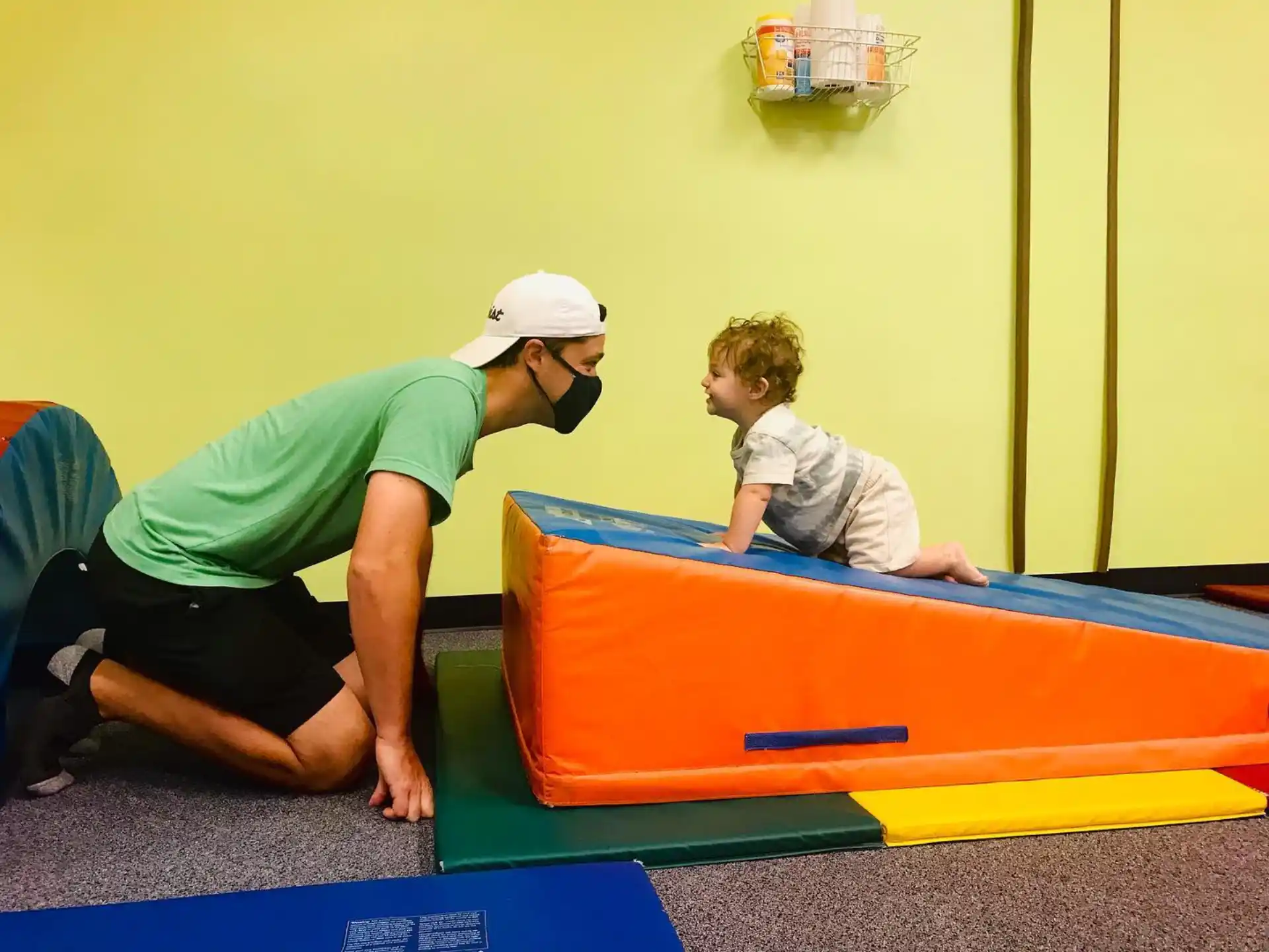 a person and a boy playing on a trampoline
