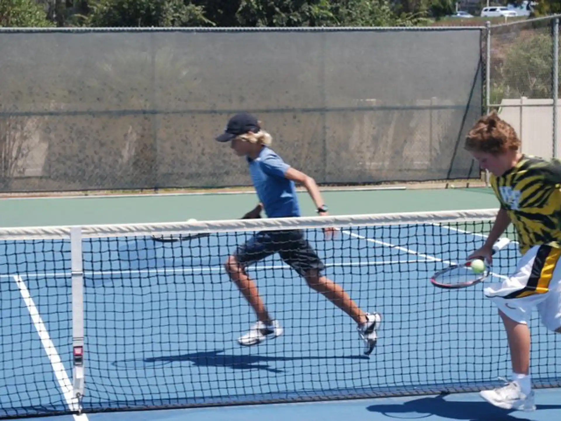 a couple of men playing tennis
