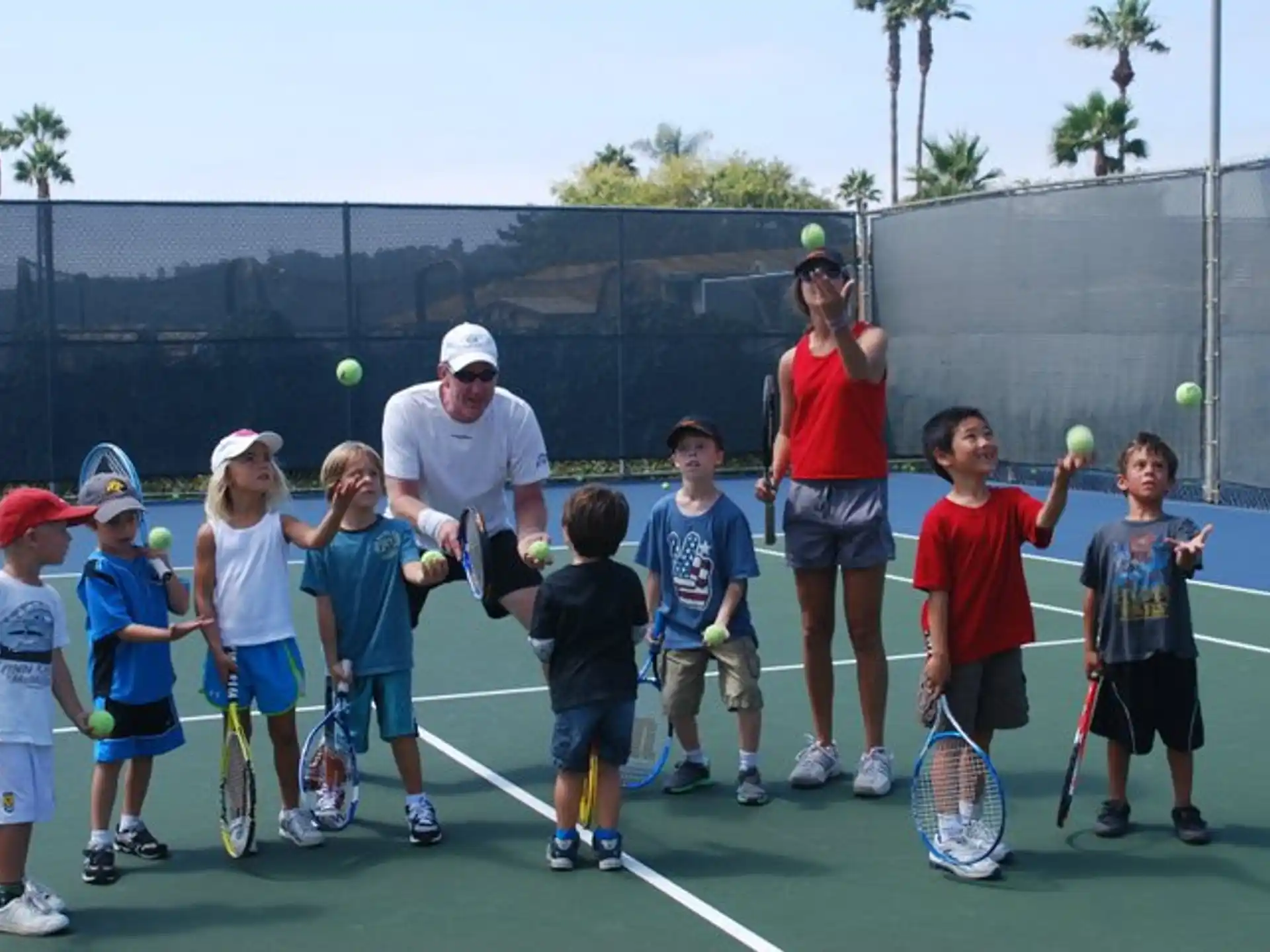 a group of kids holding tennis rackets