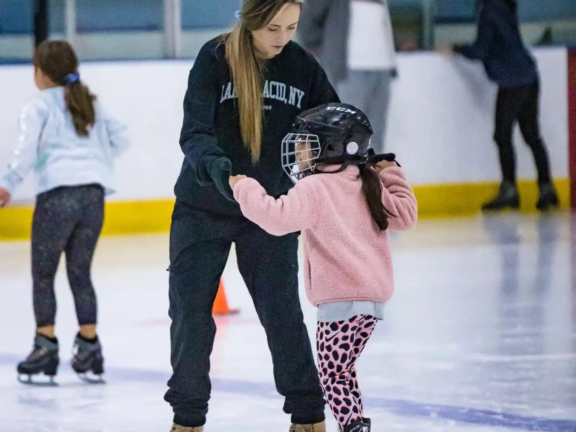a person and a girl ice skating