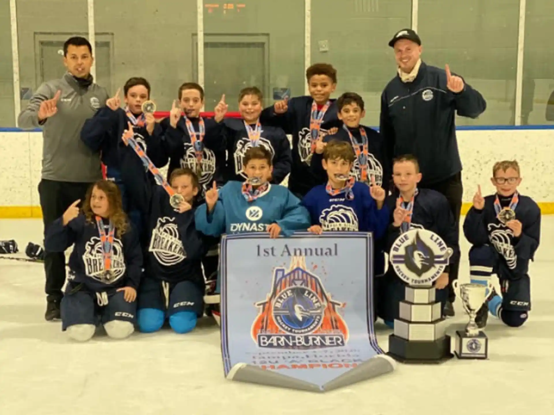 a group of people posing for a photo with a trophy