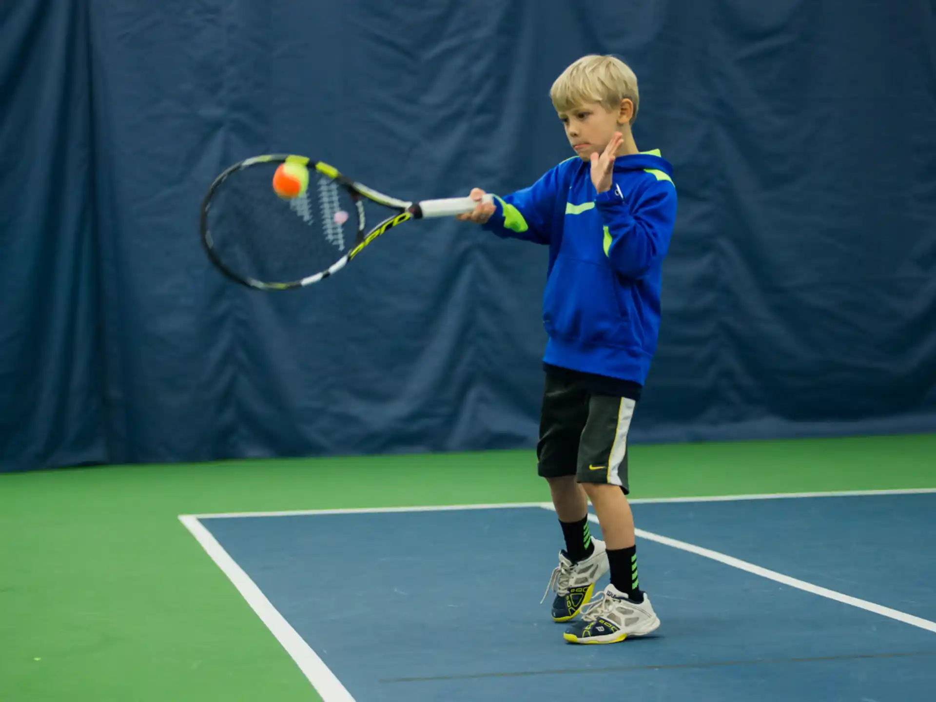 a boy playing tennis