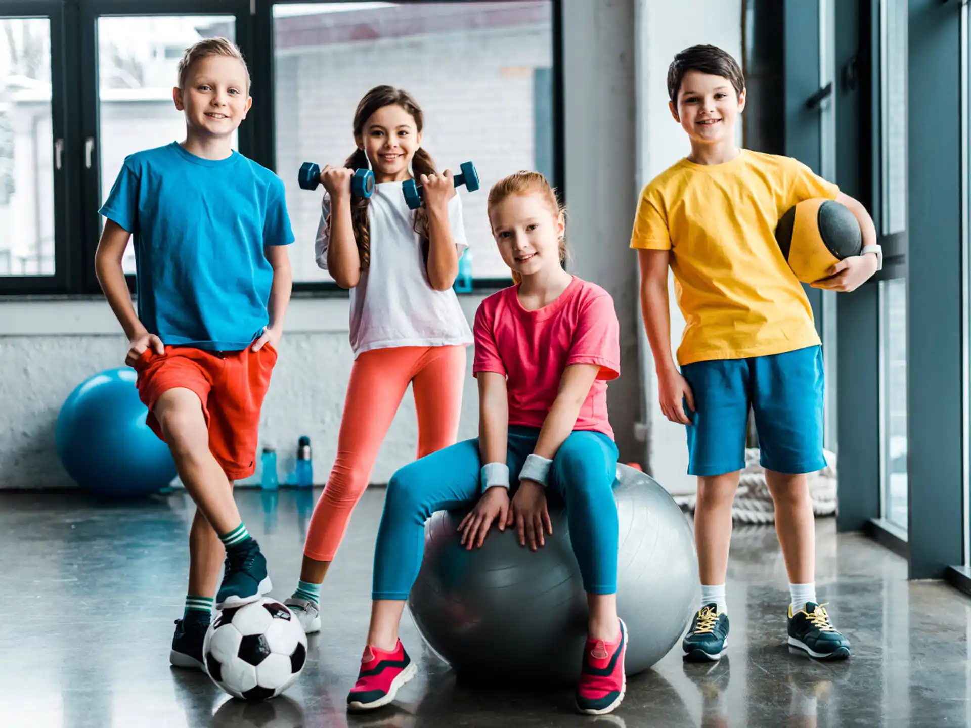 a group of people posing for a photo with exercise balls