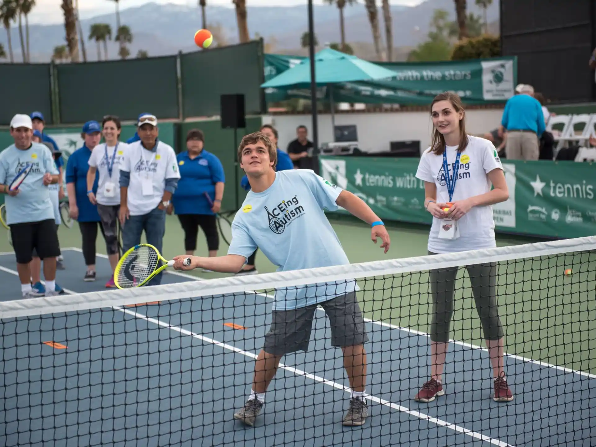 a couple of people holding tennis rackets on a tennis court