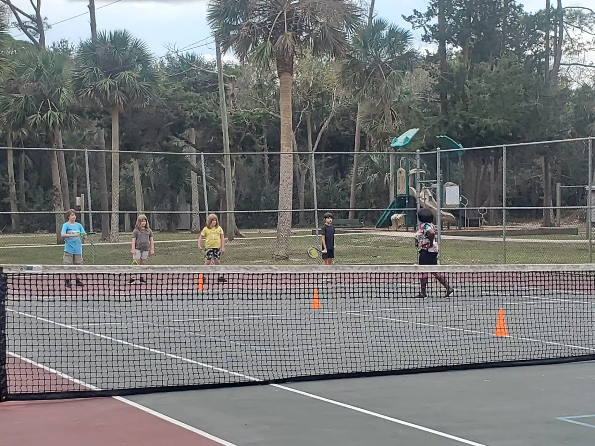 kids playing tennis on a court