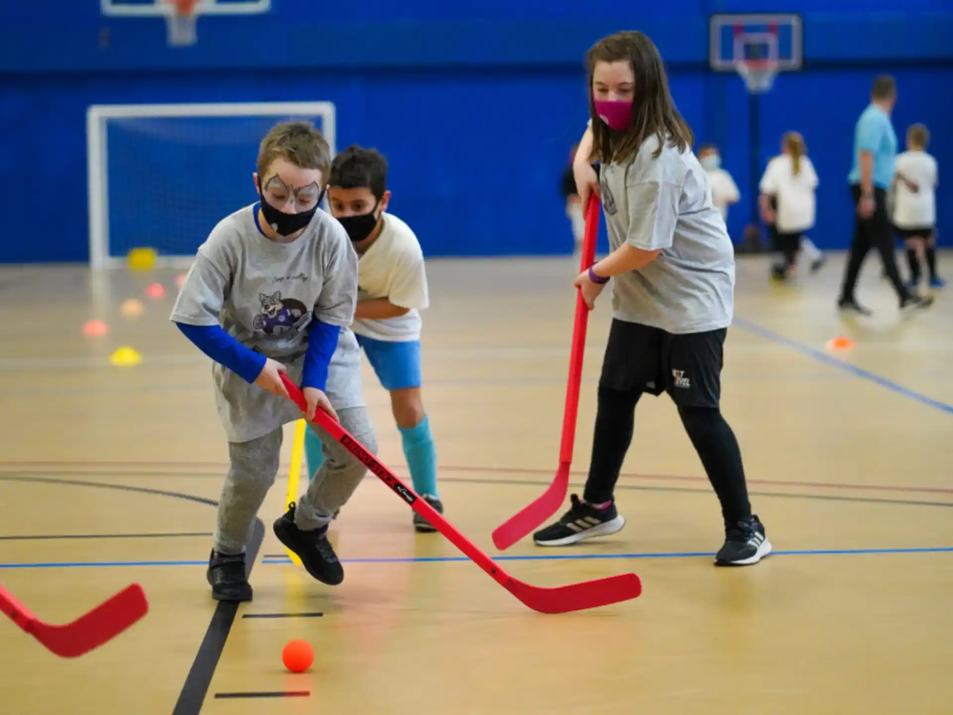 a group of kids playing hockey