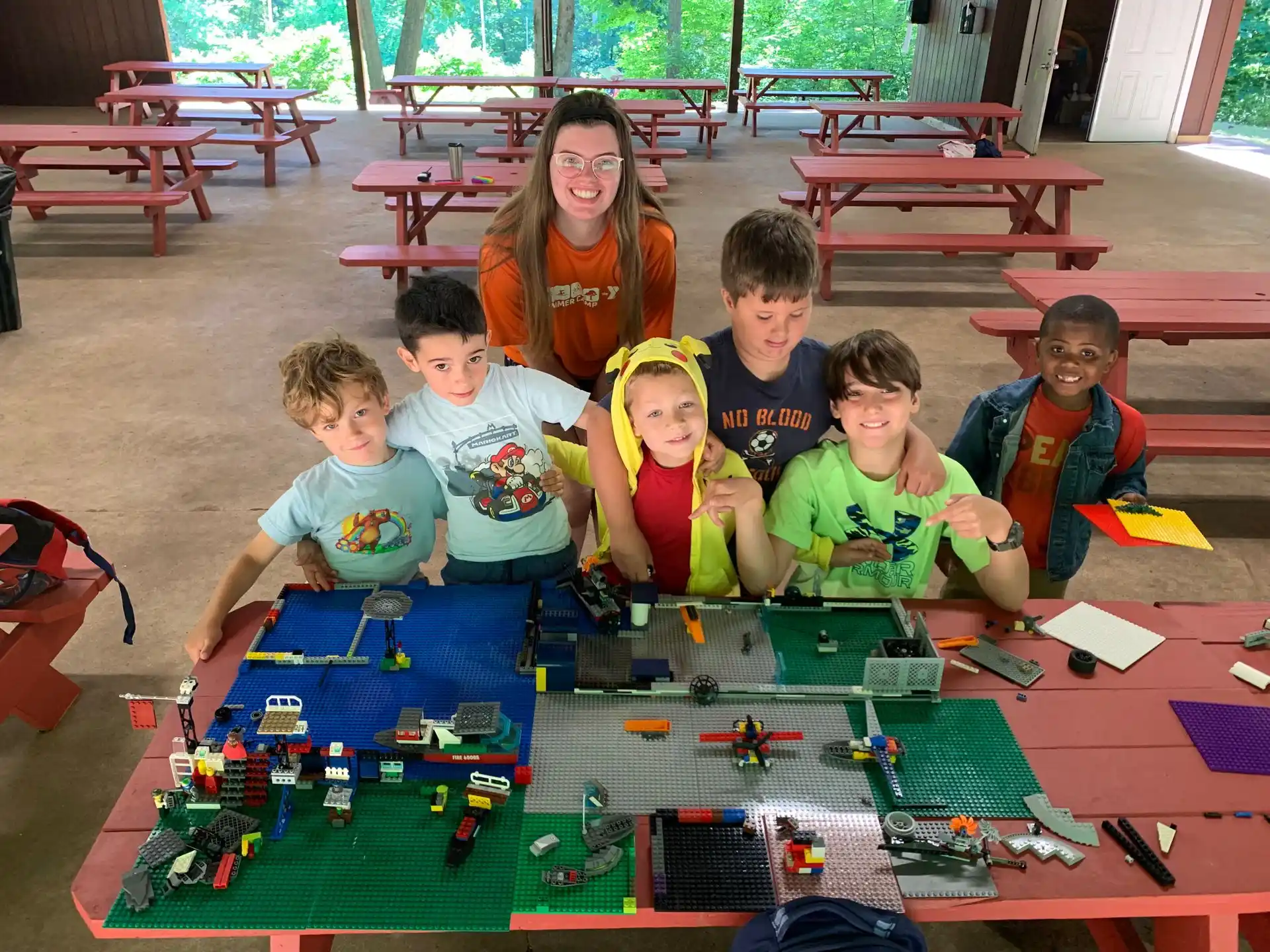 a group of children sitting on the floor playing with toys