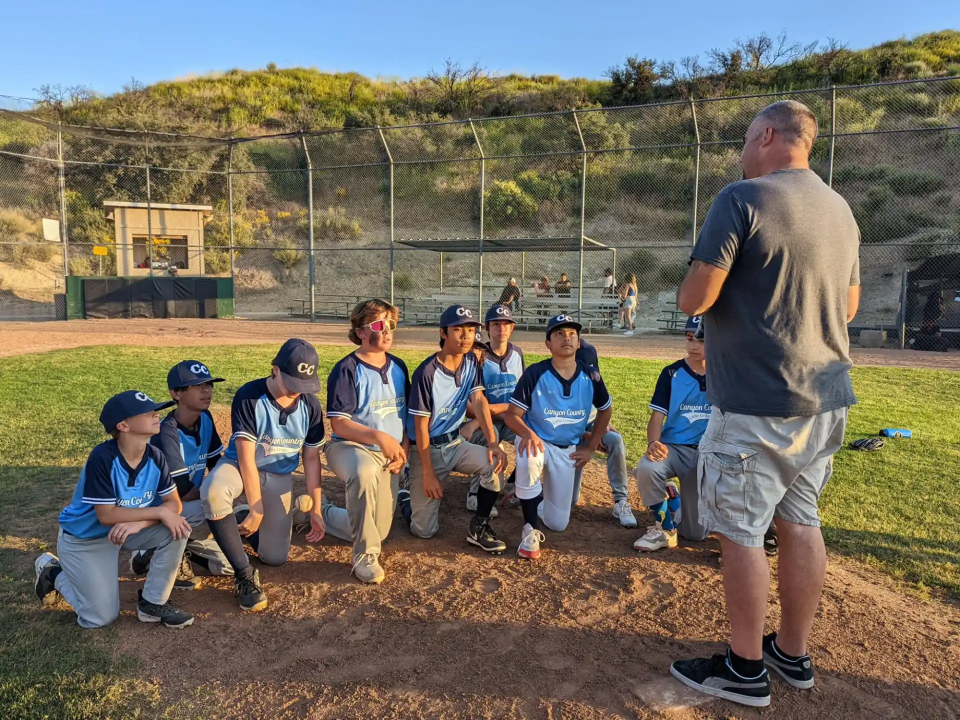 a baseball player talking to a group of kids