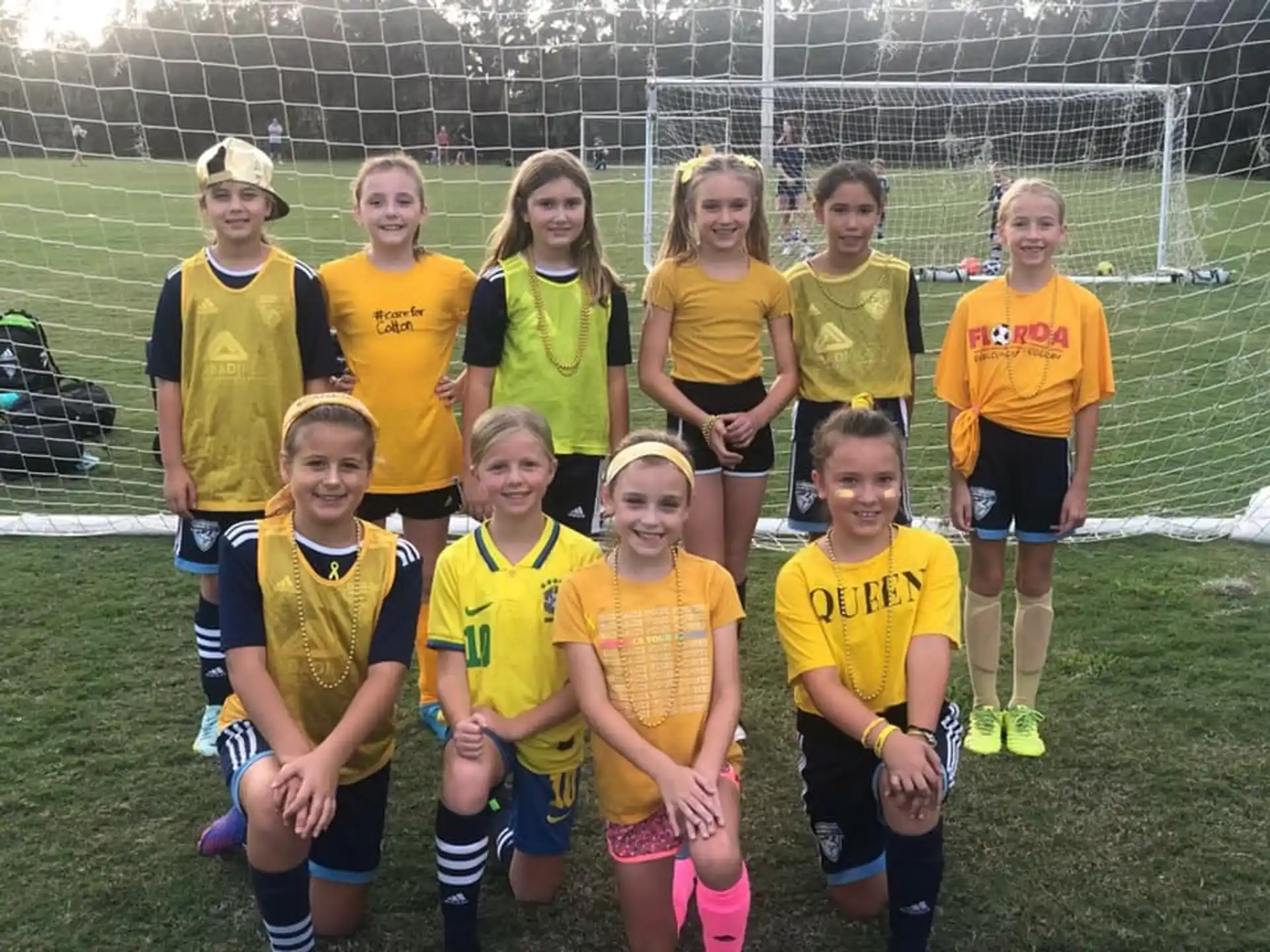 a group of girls in yellow shirts