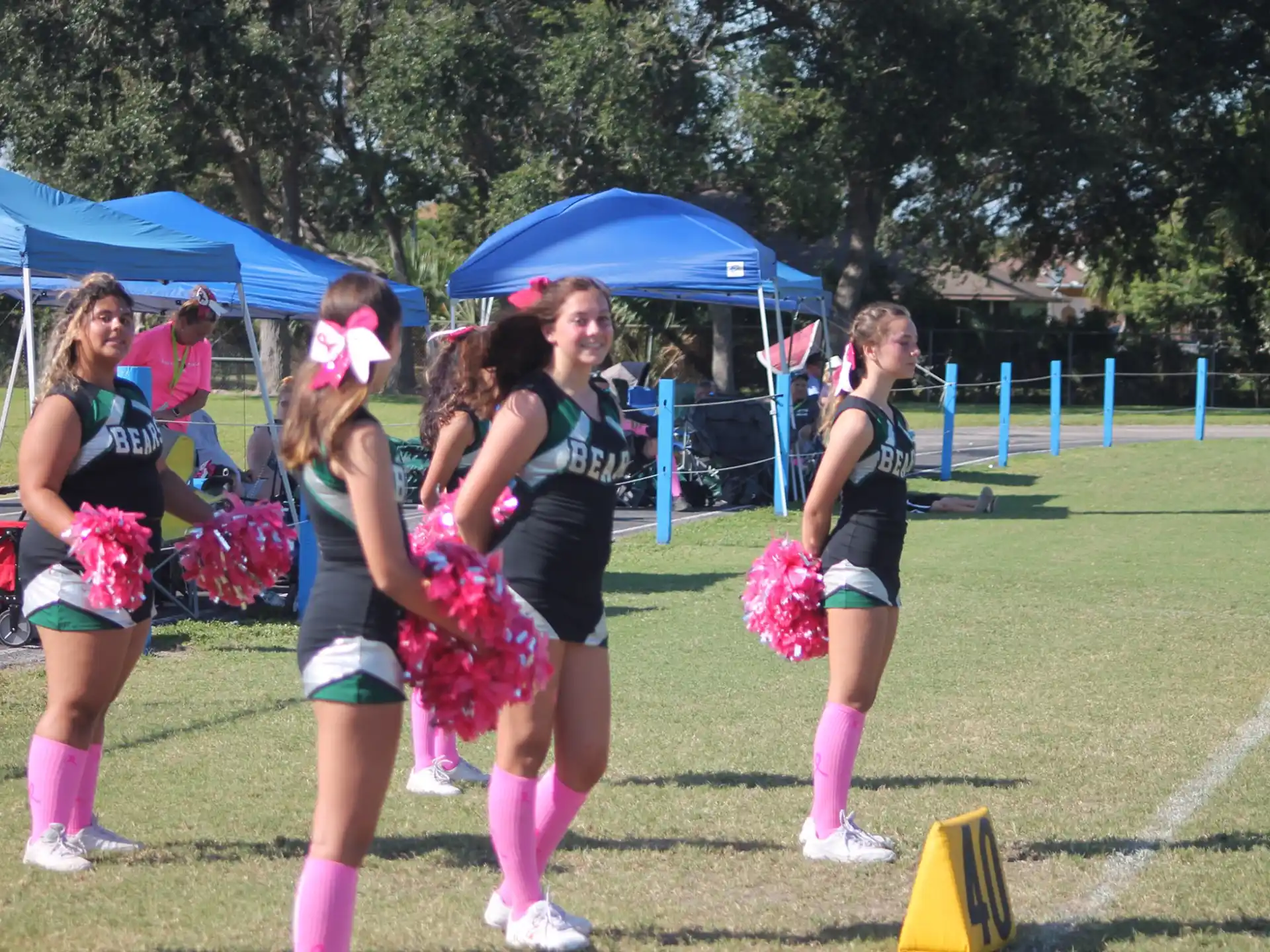 a group of cheerleaders on a field