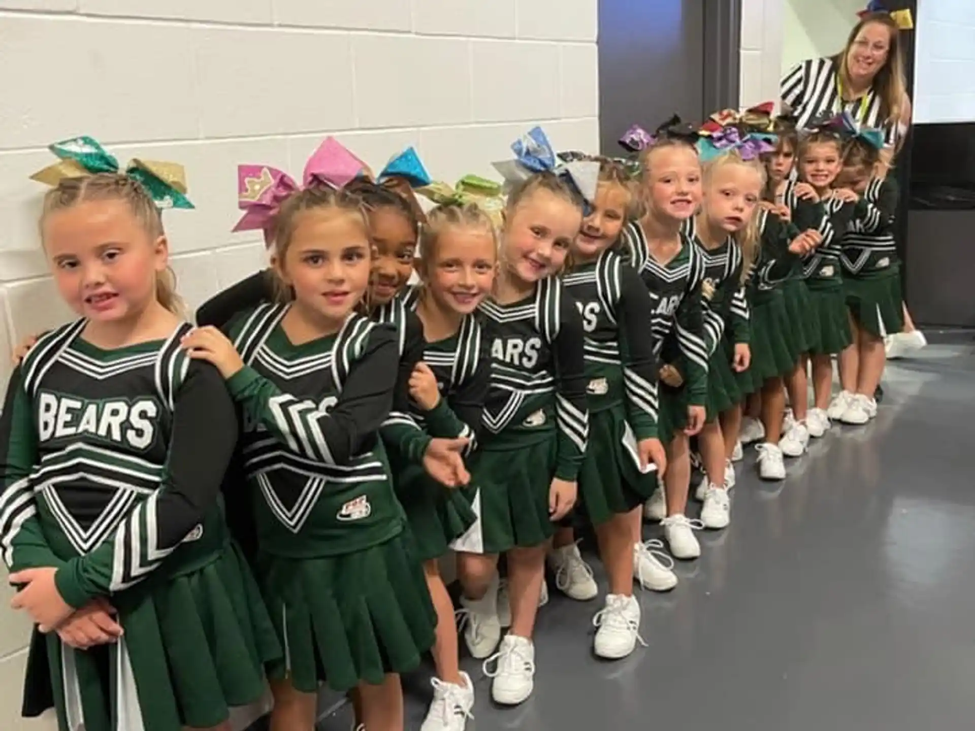 a group of girls in green and white uniforms