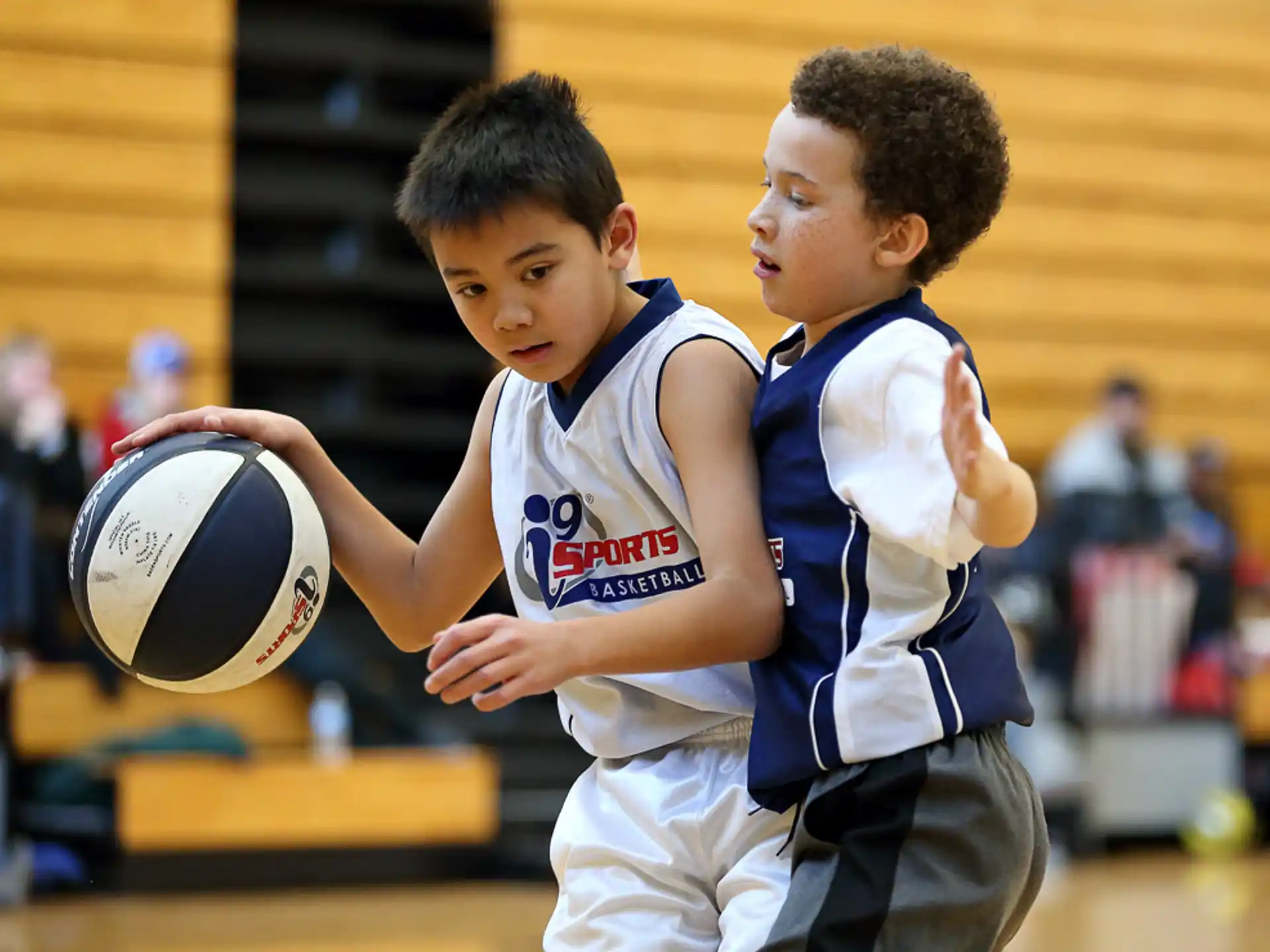 a couple of boys playing basketball