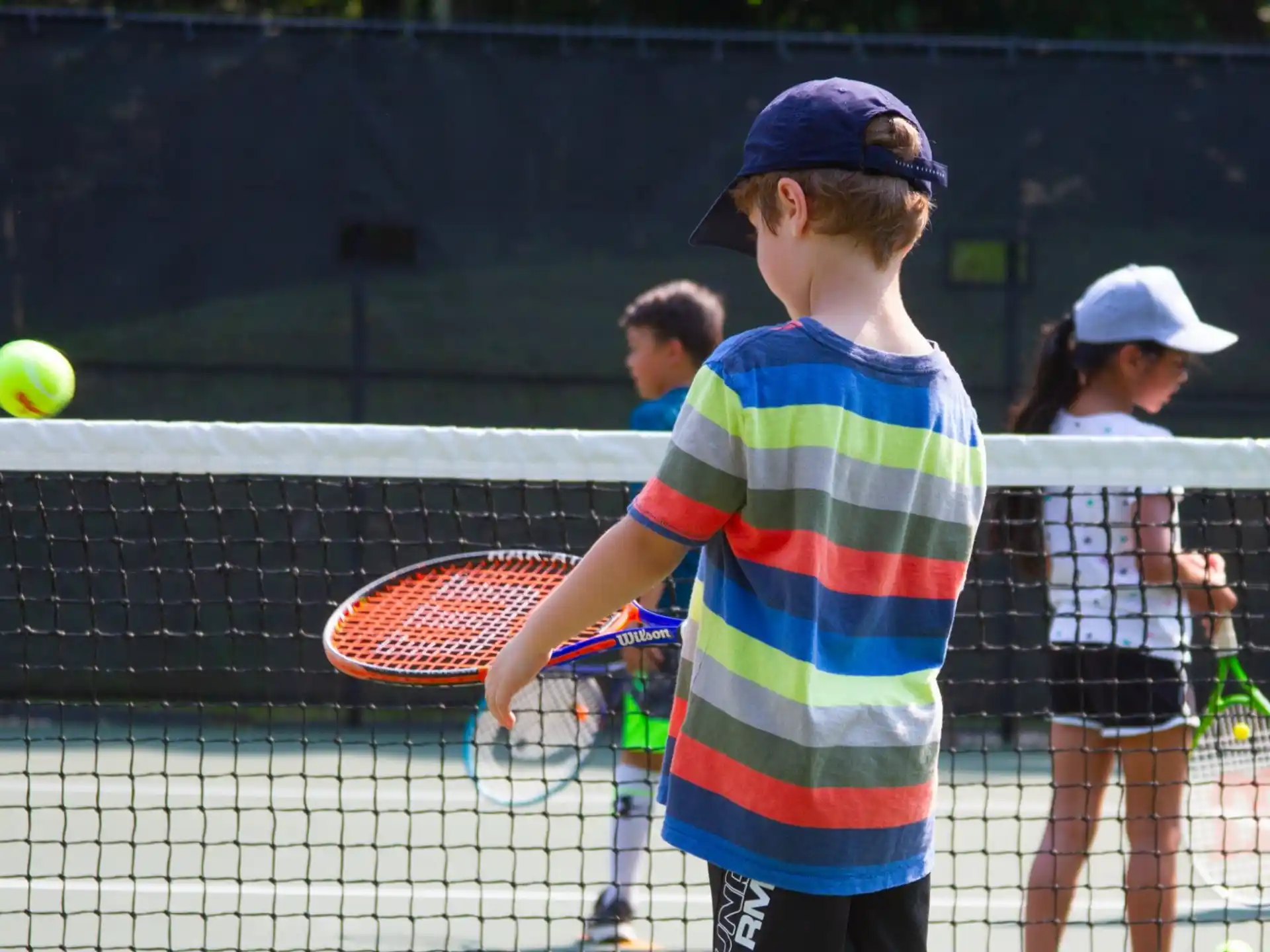 a boy playing tennis
