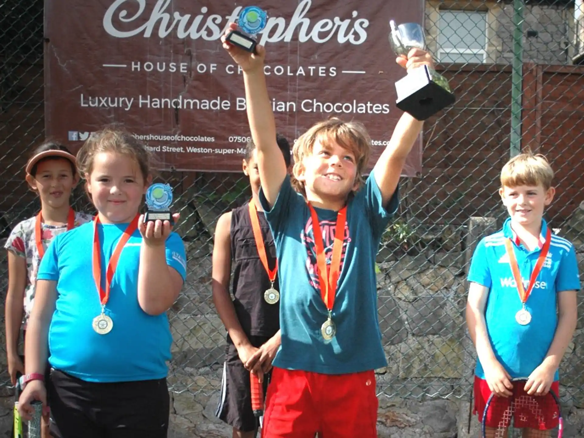 a group of boys holding trophies