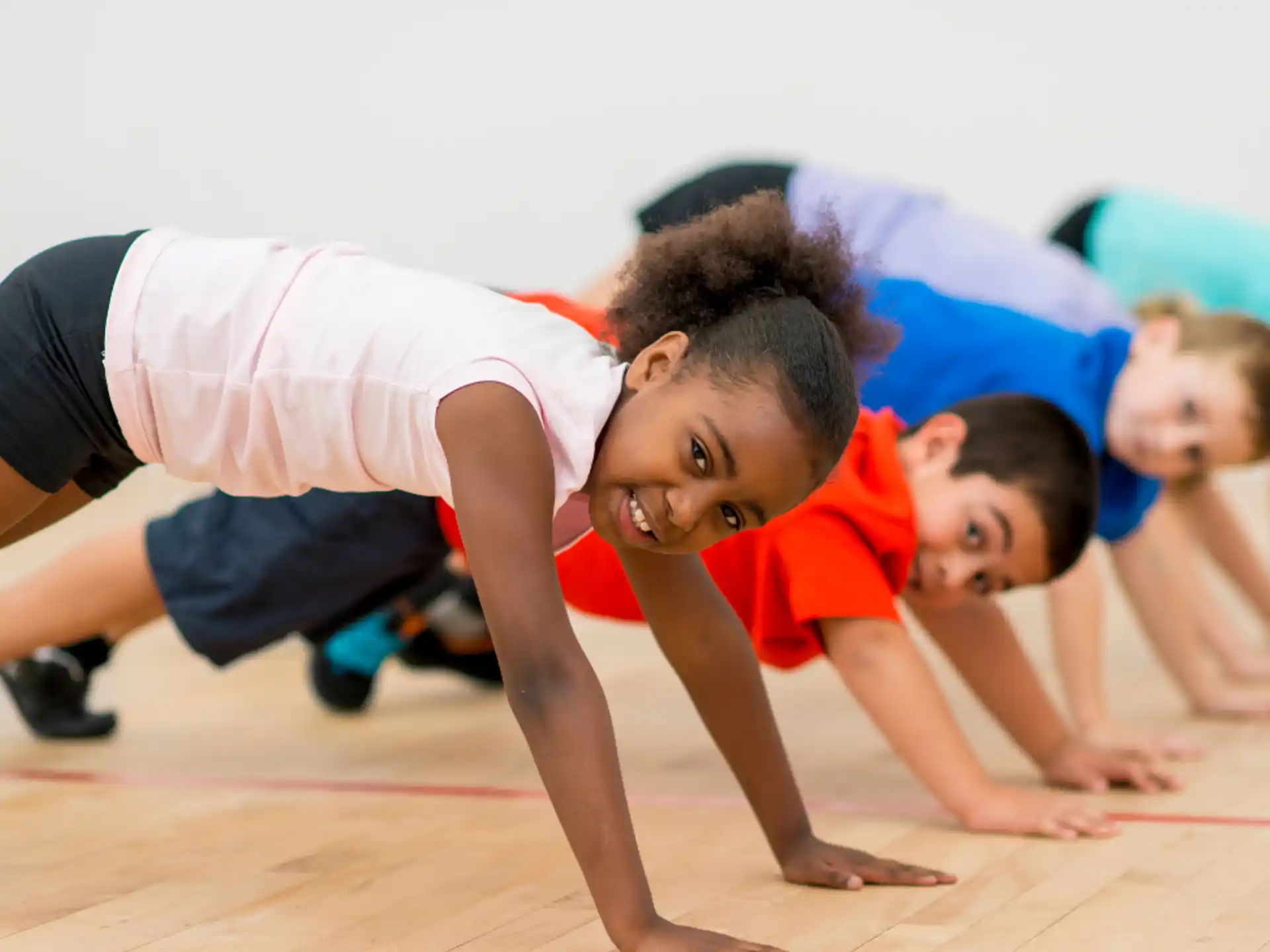 a group of children doing push ups
