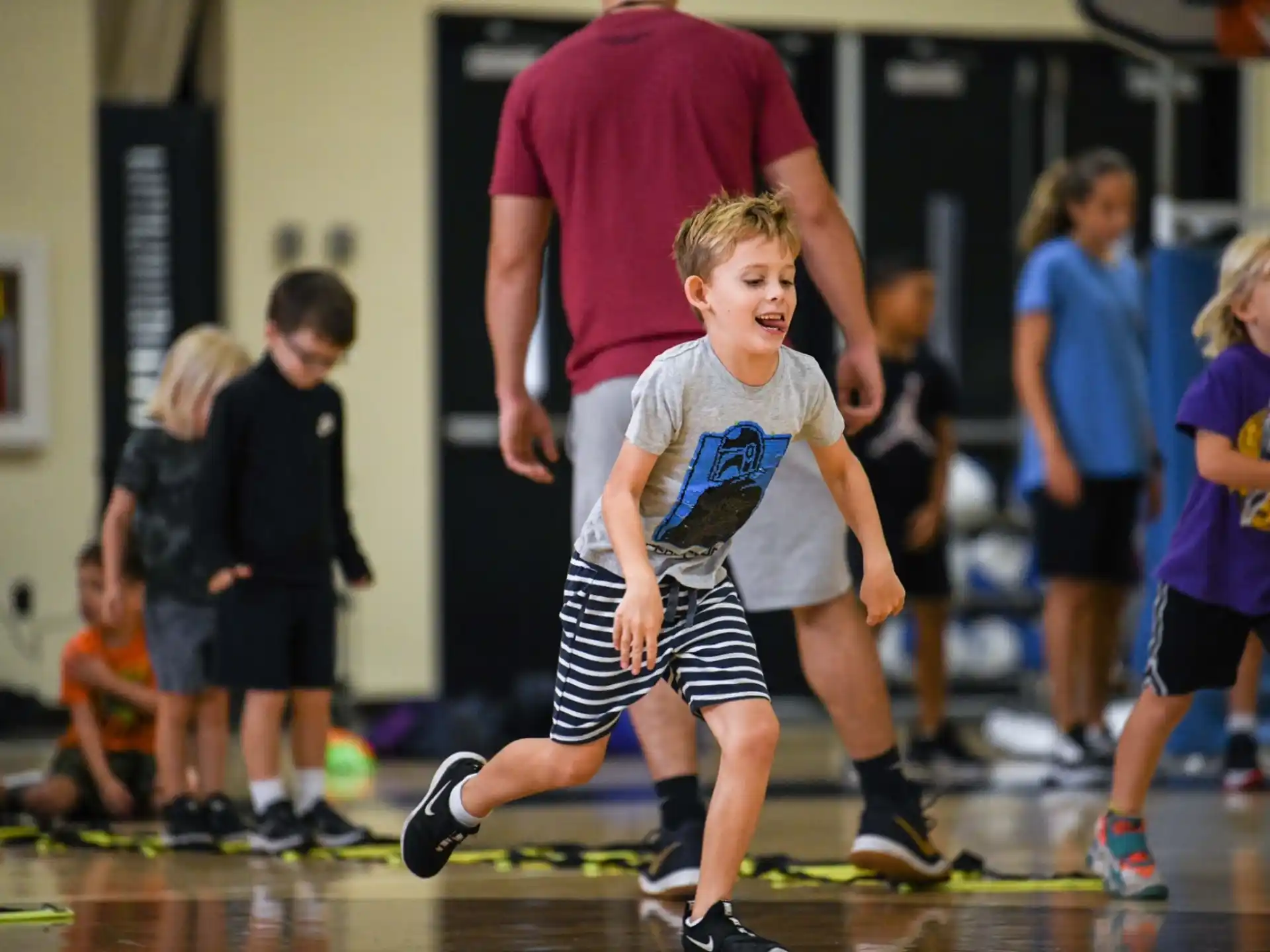 a boy running on a basketball court