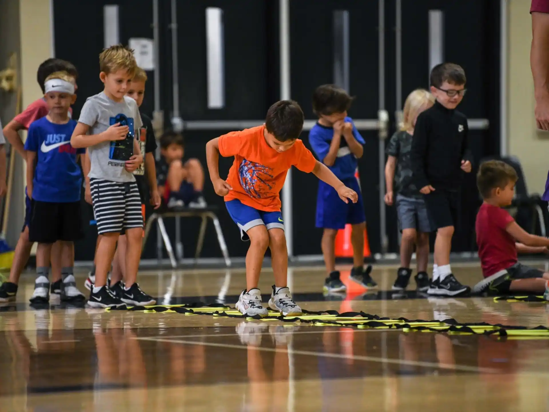 a group of children playing basketball