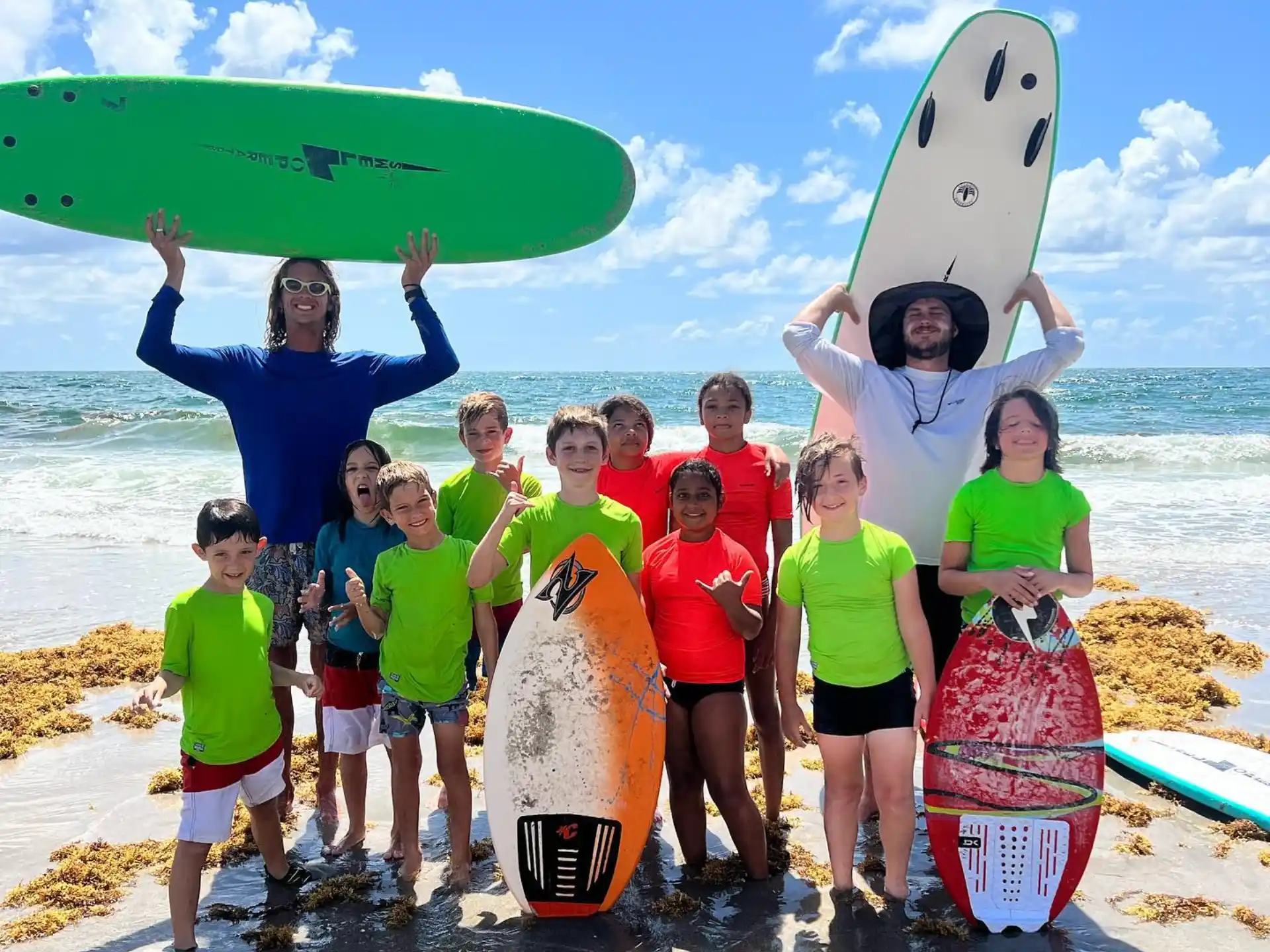 a group of people holding surfboards