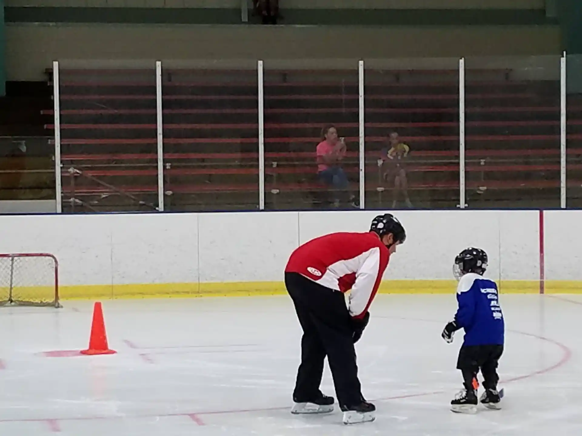 a person and a child on an ice rink