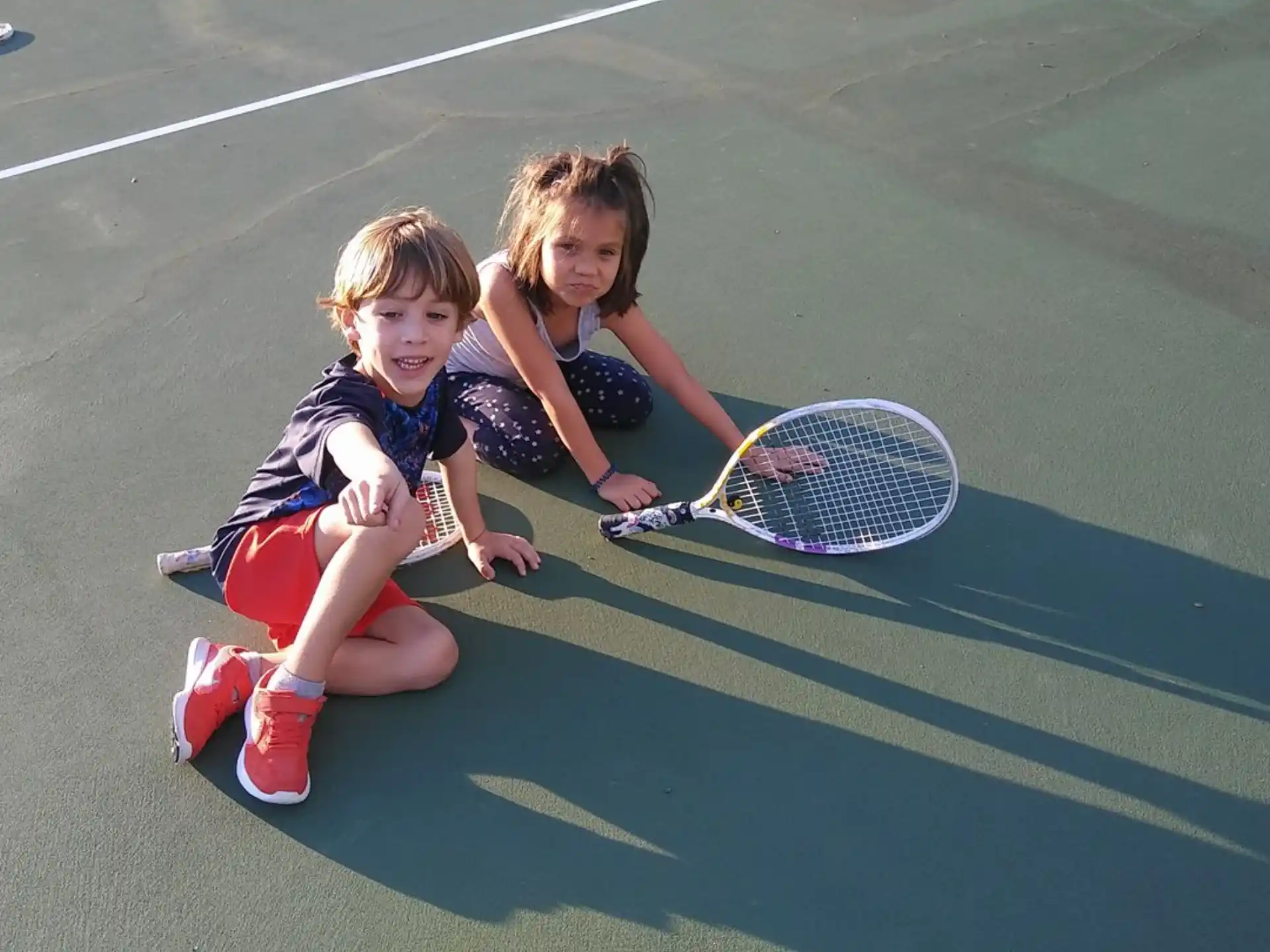 two girls playing tennis