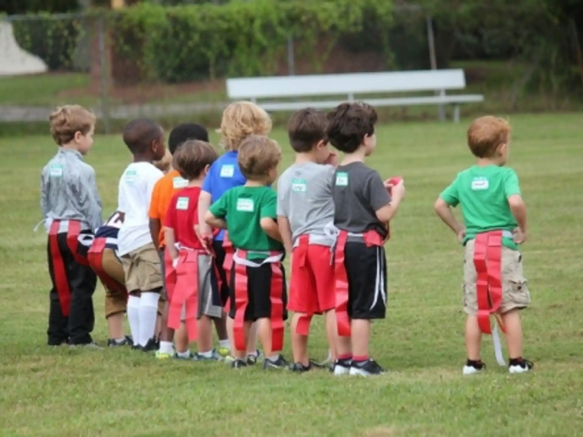 a group of kids standing on a field