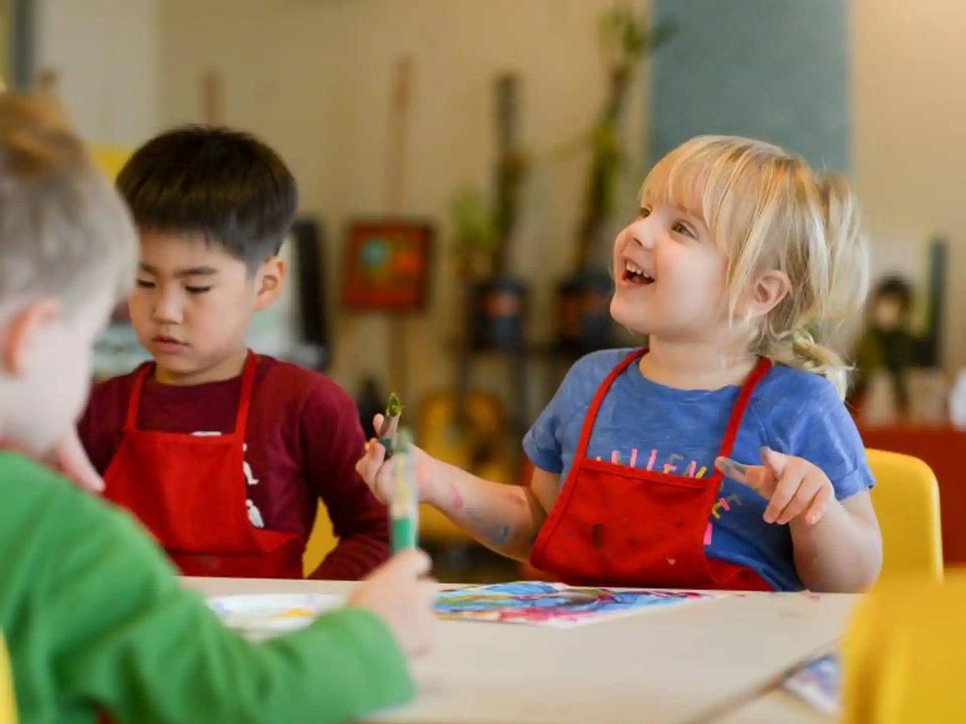 a few children sitting at a table