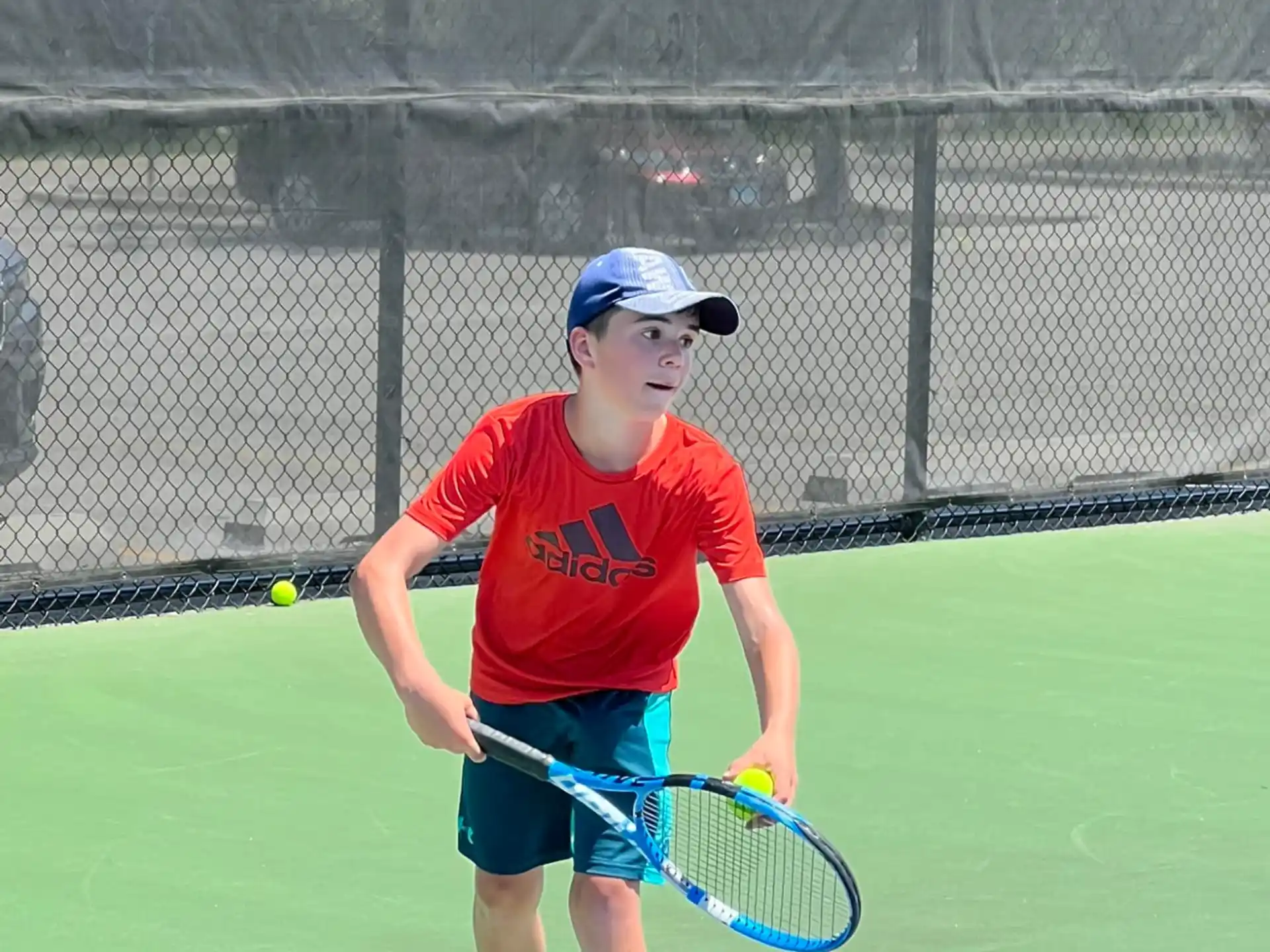 a boy playing tennis