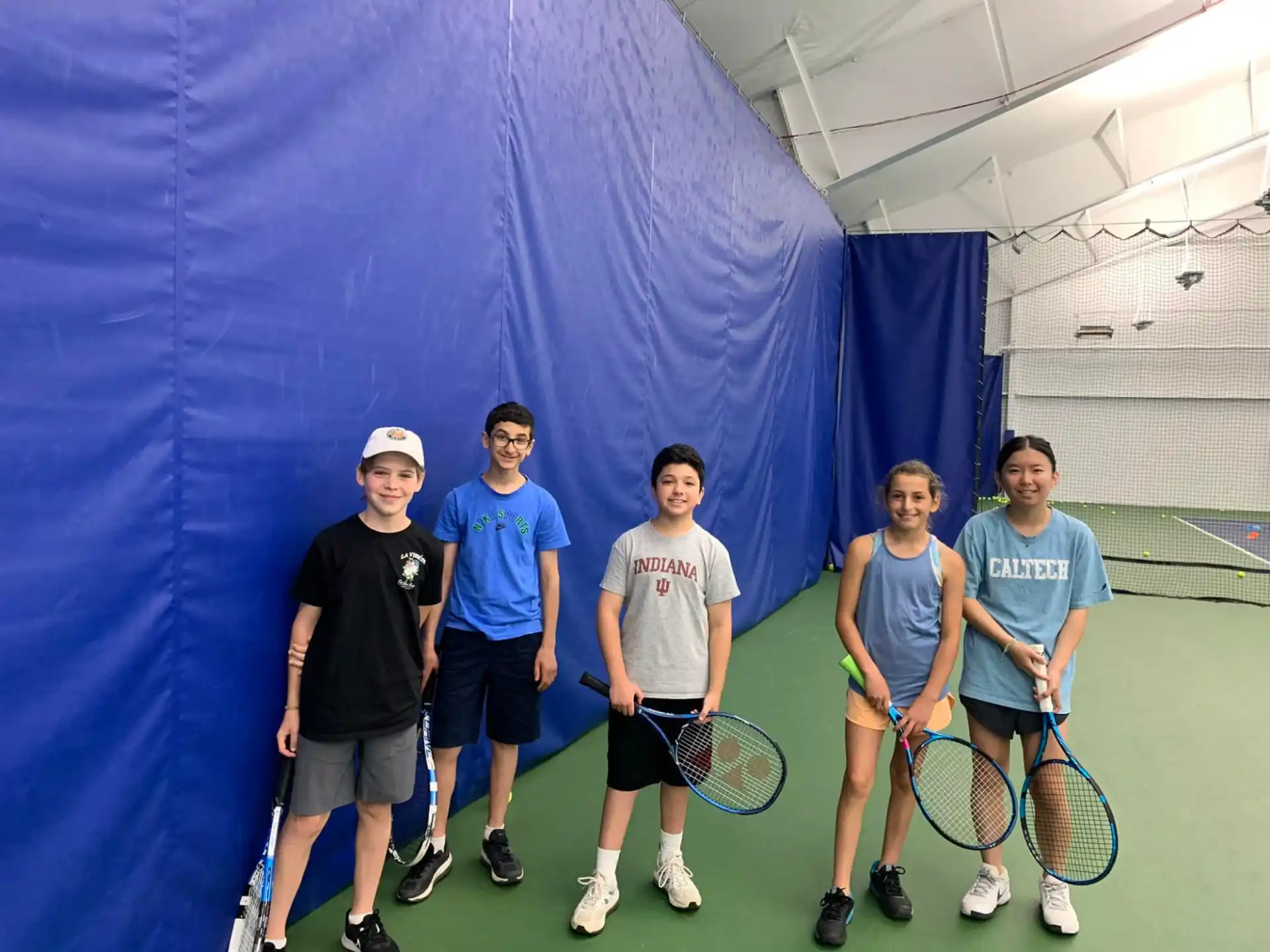 a group of people holding tennis rackets