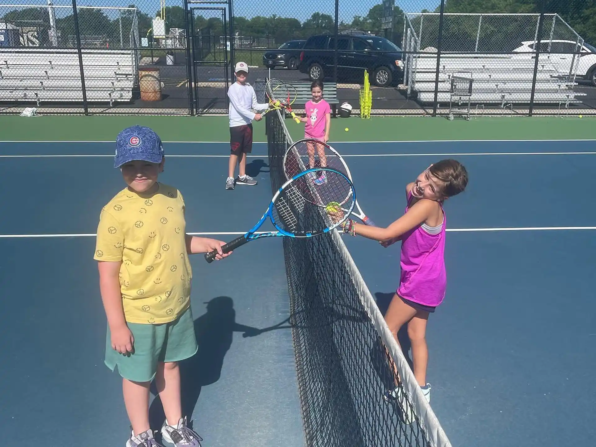kids playing tennis on a court
