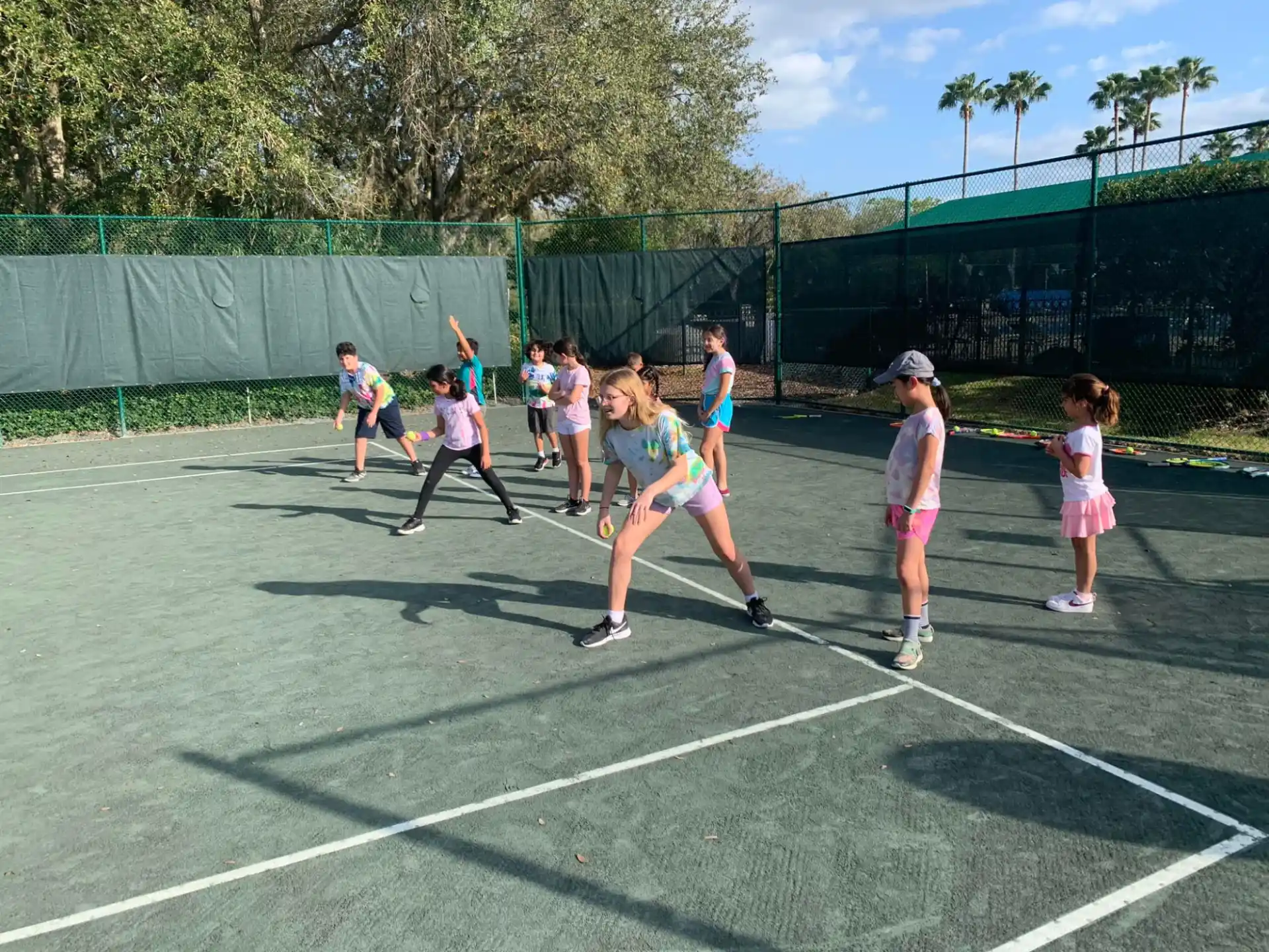 a group of girls playing tennis