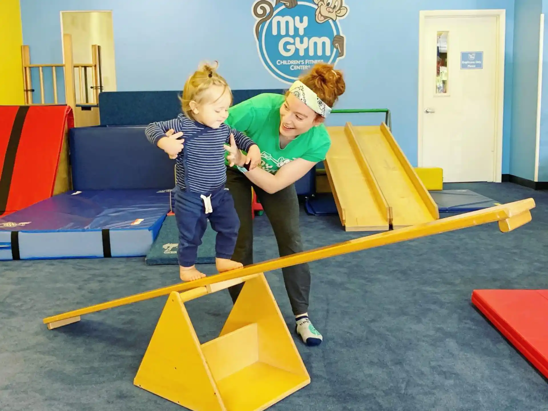 a couple of kids playing on a playground toy