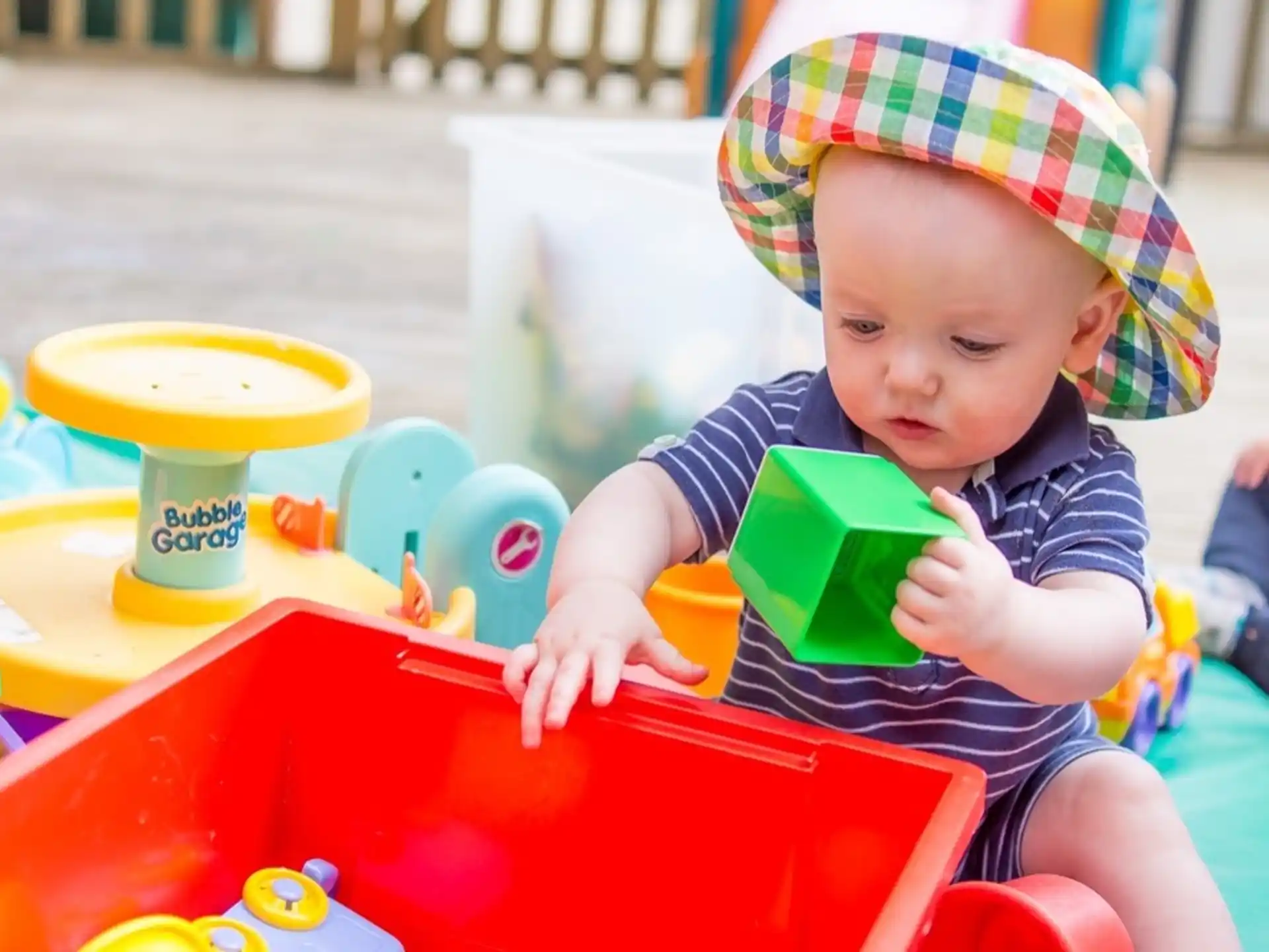 a baby sitting in a highchair with a book in his hand