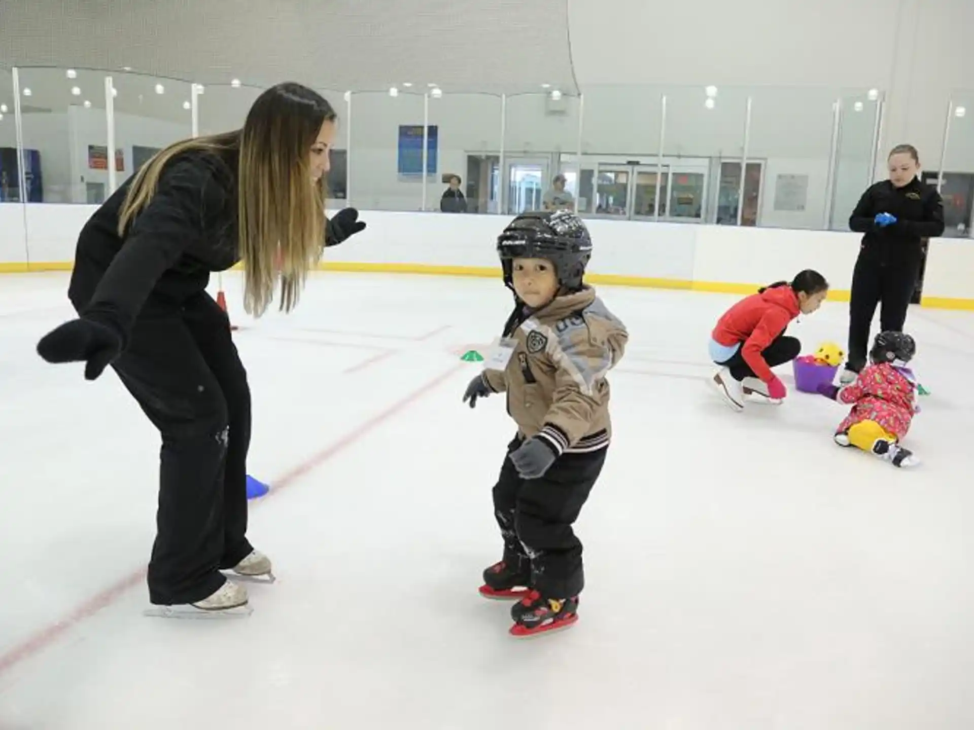 a person and a child on an ice rink