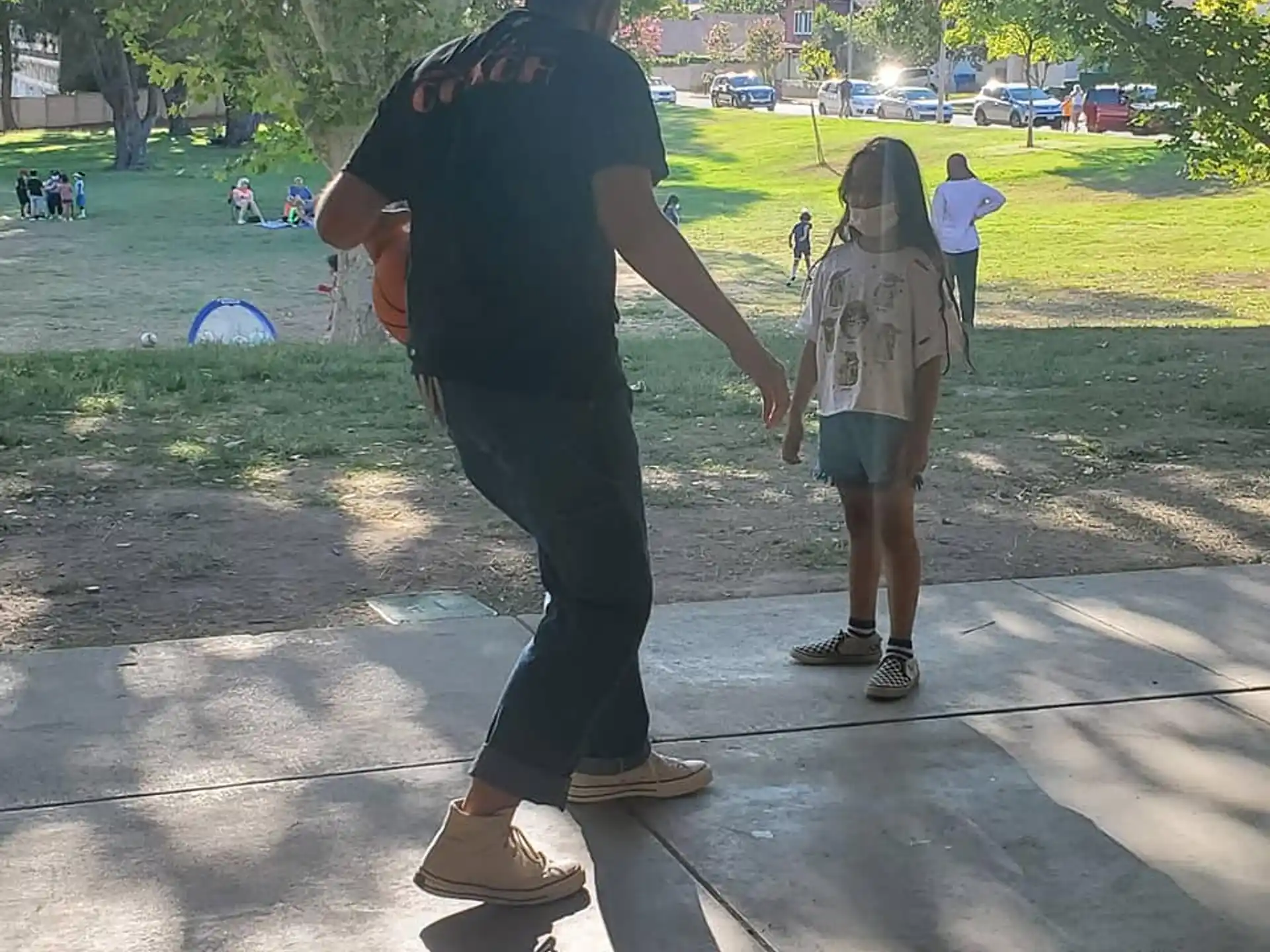 a man and a child walking on a sidewalk