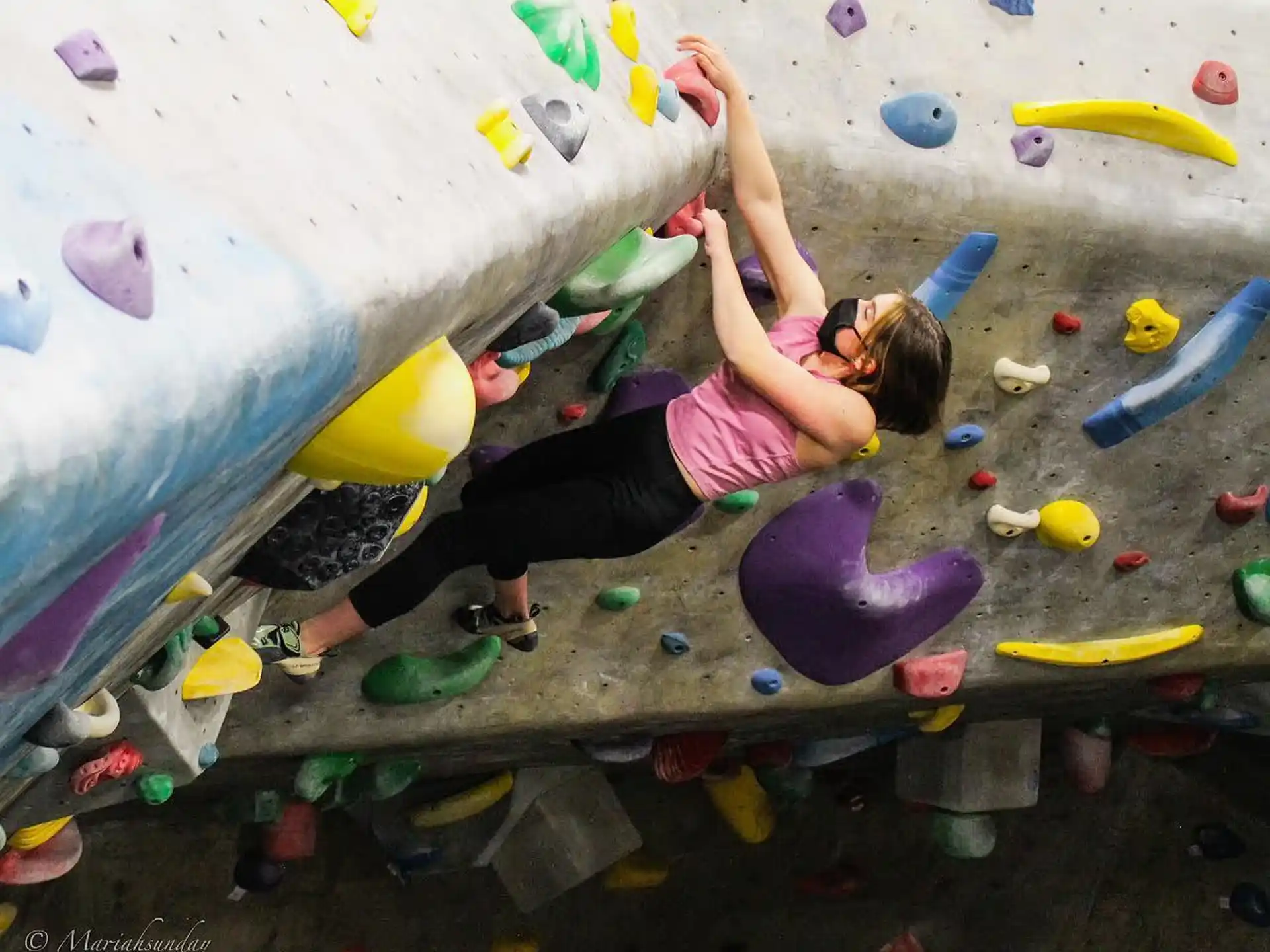 a girl climbing a rock wall