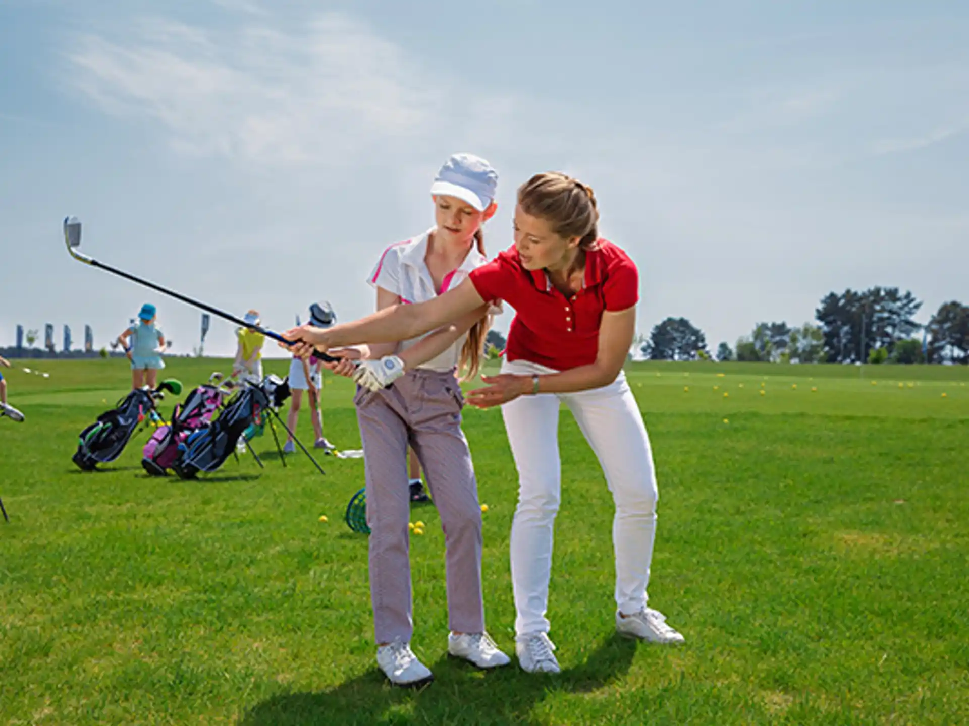 a couple of people playing golf