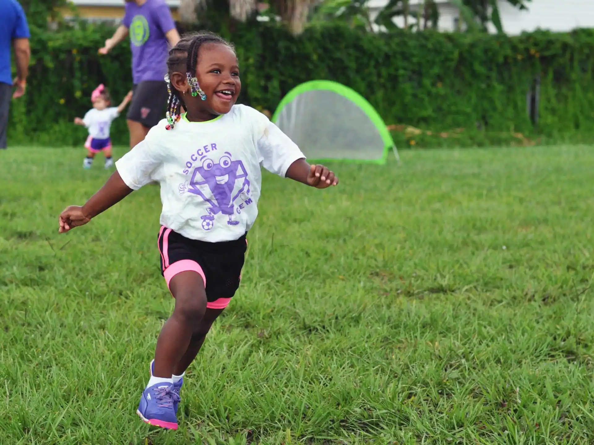 a girl running in a grassy area