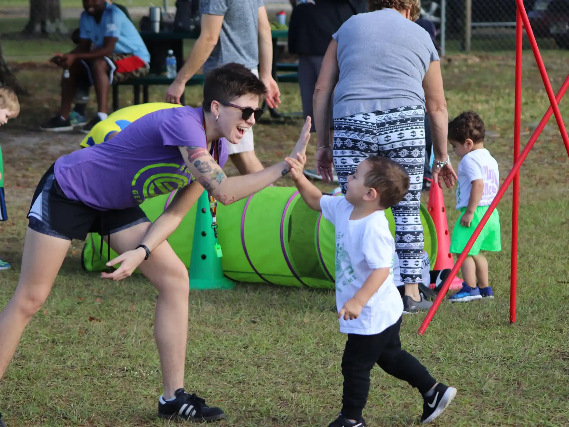 a person helping a child play on a playground