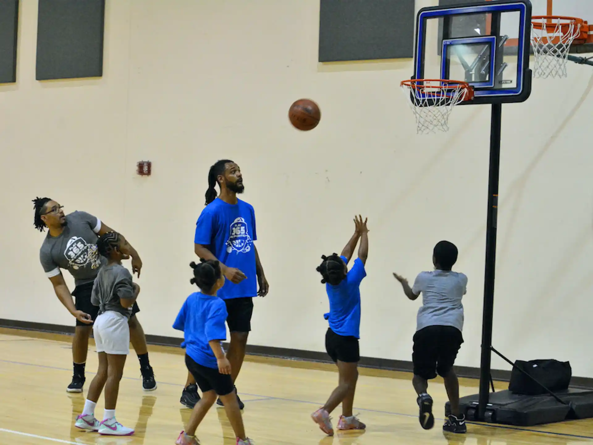 a group of people playing basketball
