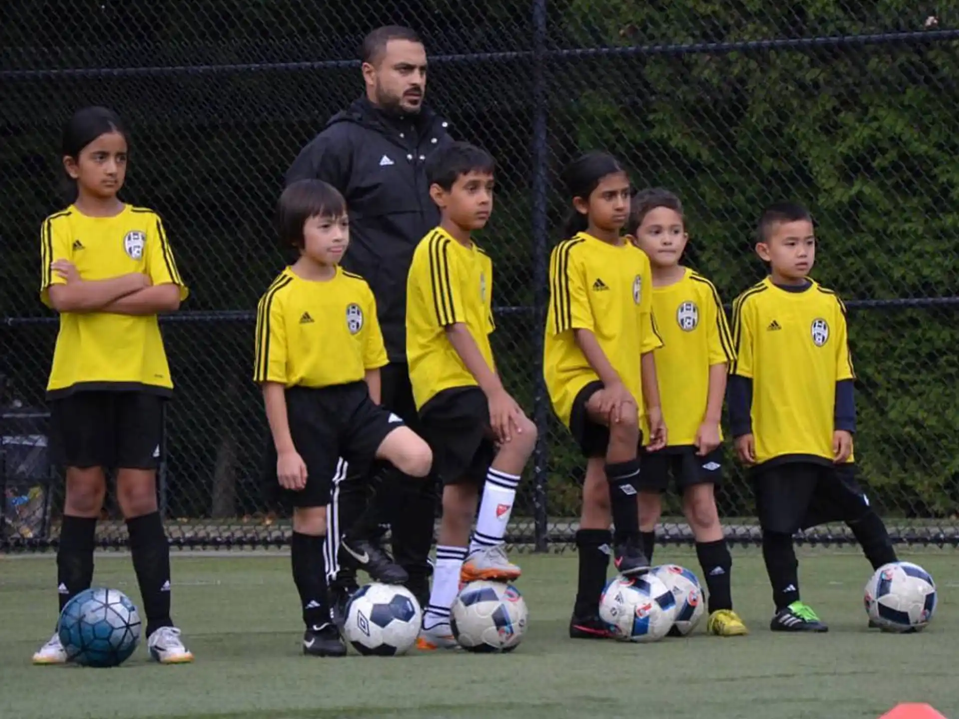 a group of kids in yellow uniforms