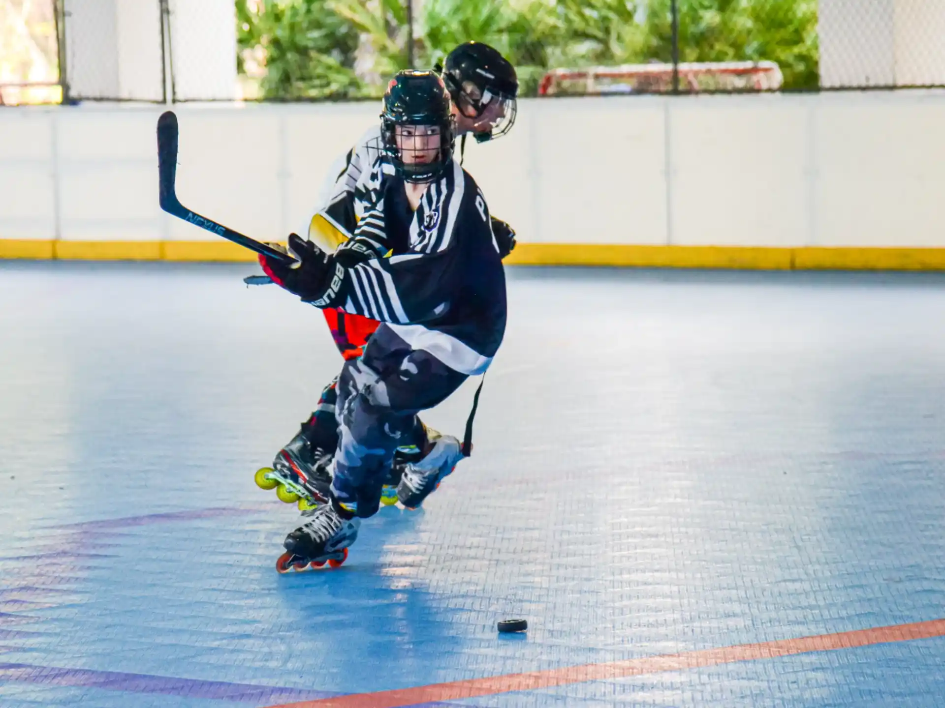 a man wearing roller skates and holding a hockey stick
