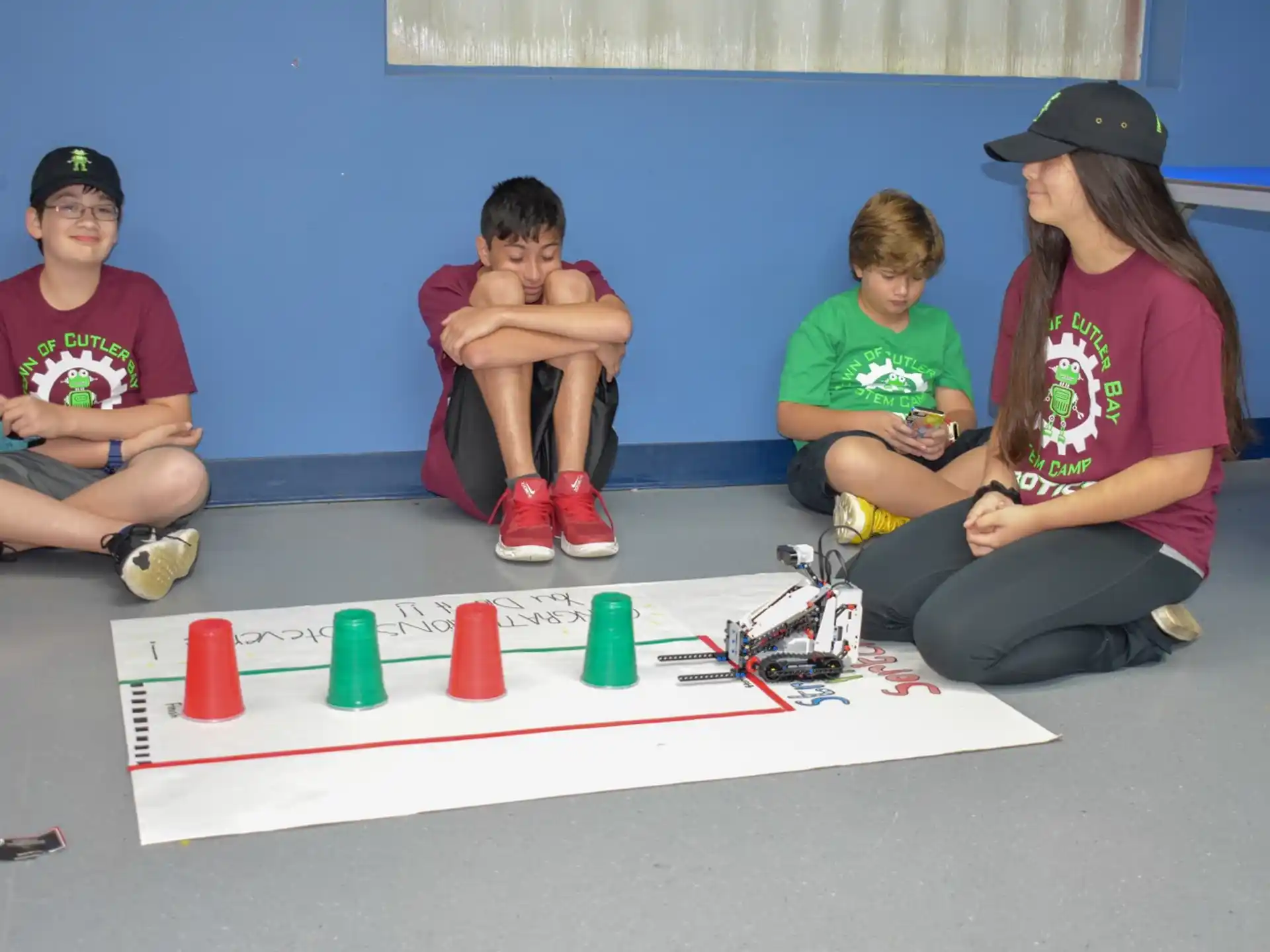 a group of people sitting on the floor playing a board game