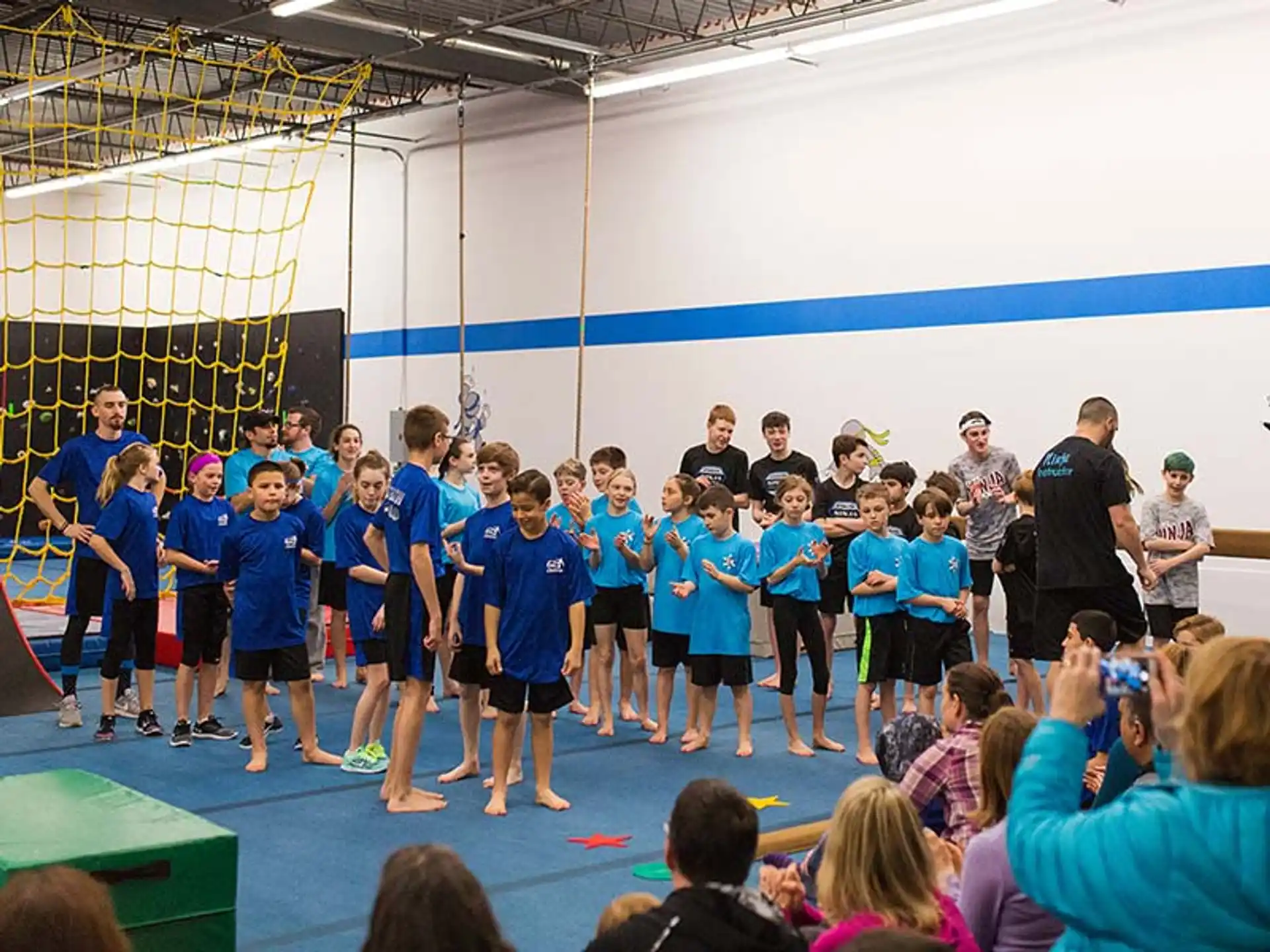 a group of children in blue shirts