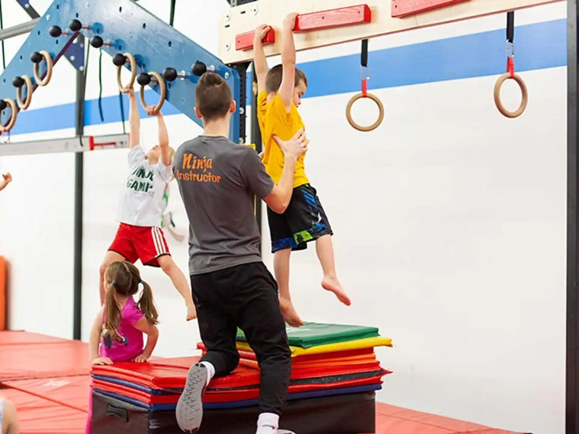a group of kids playing on a gym mat