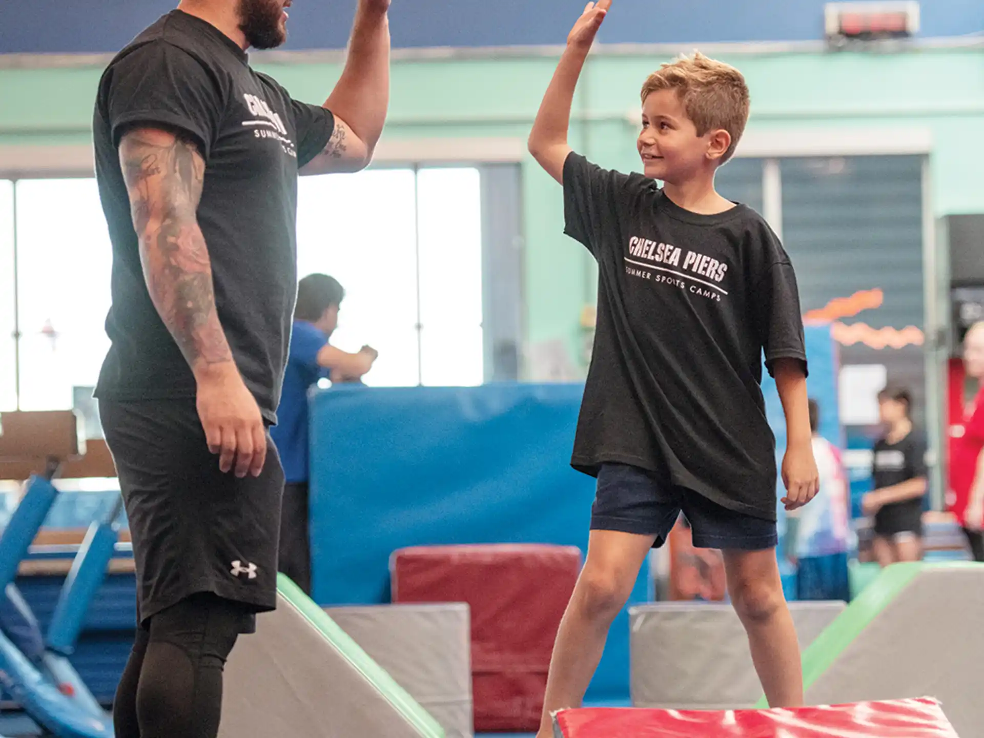 a man and a boy in a gym