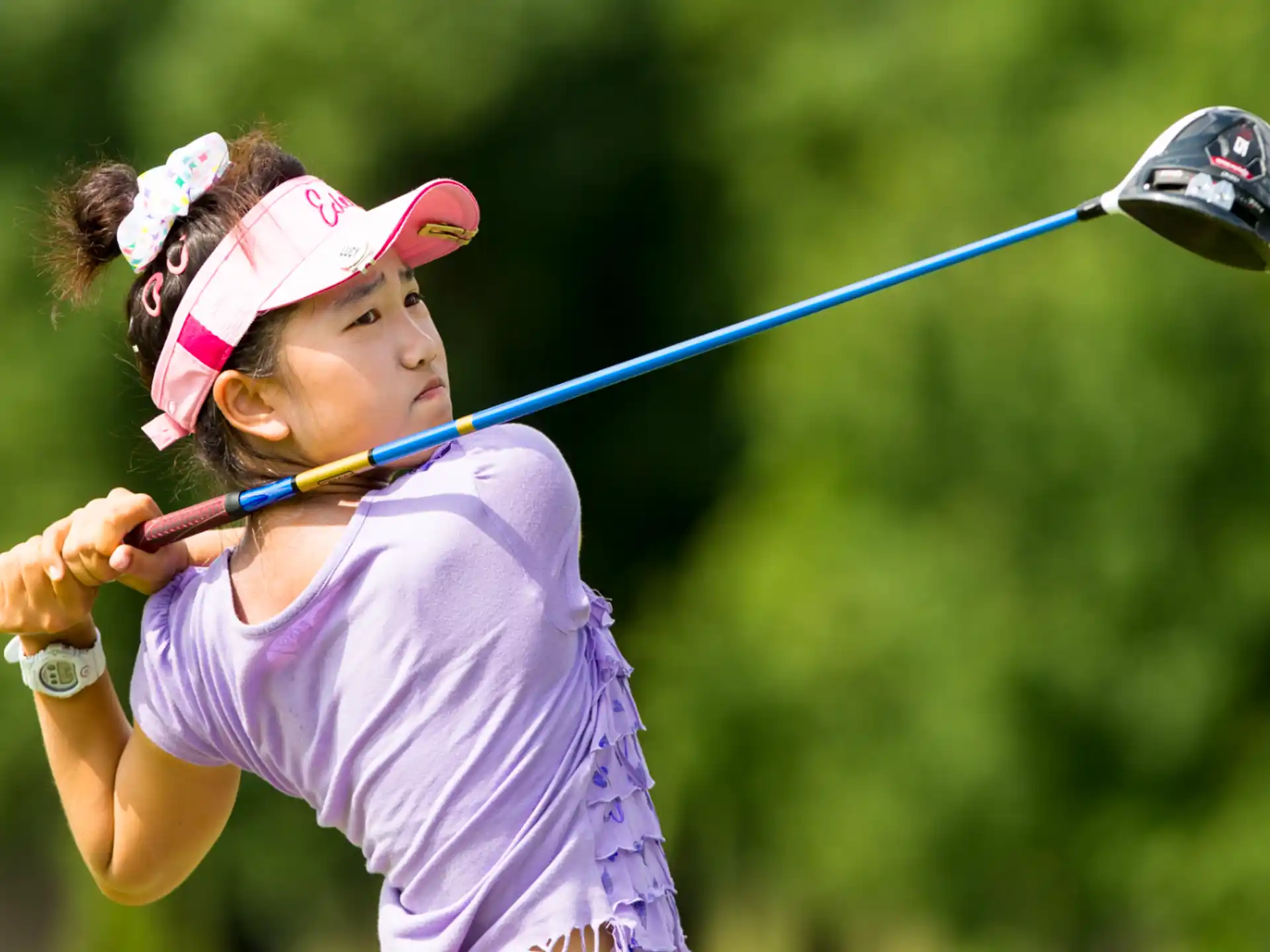a person swinging a golf club