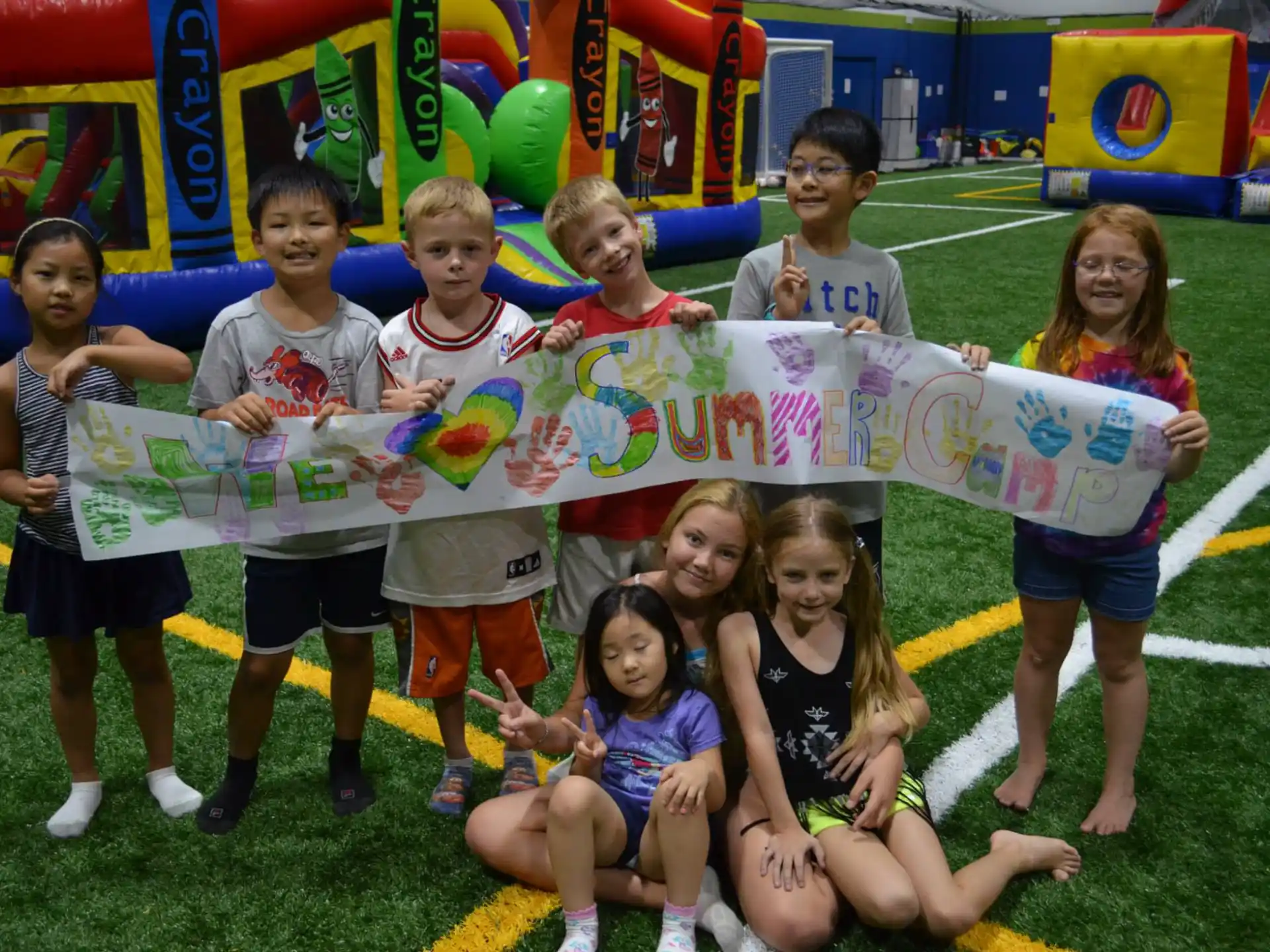 a group of kids holding a sign