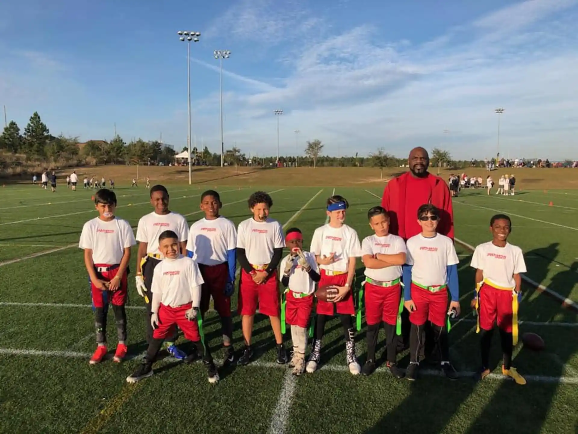 a group of children posing for a photo on a field